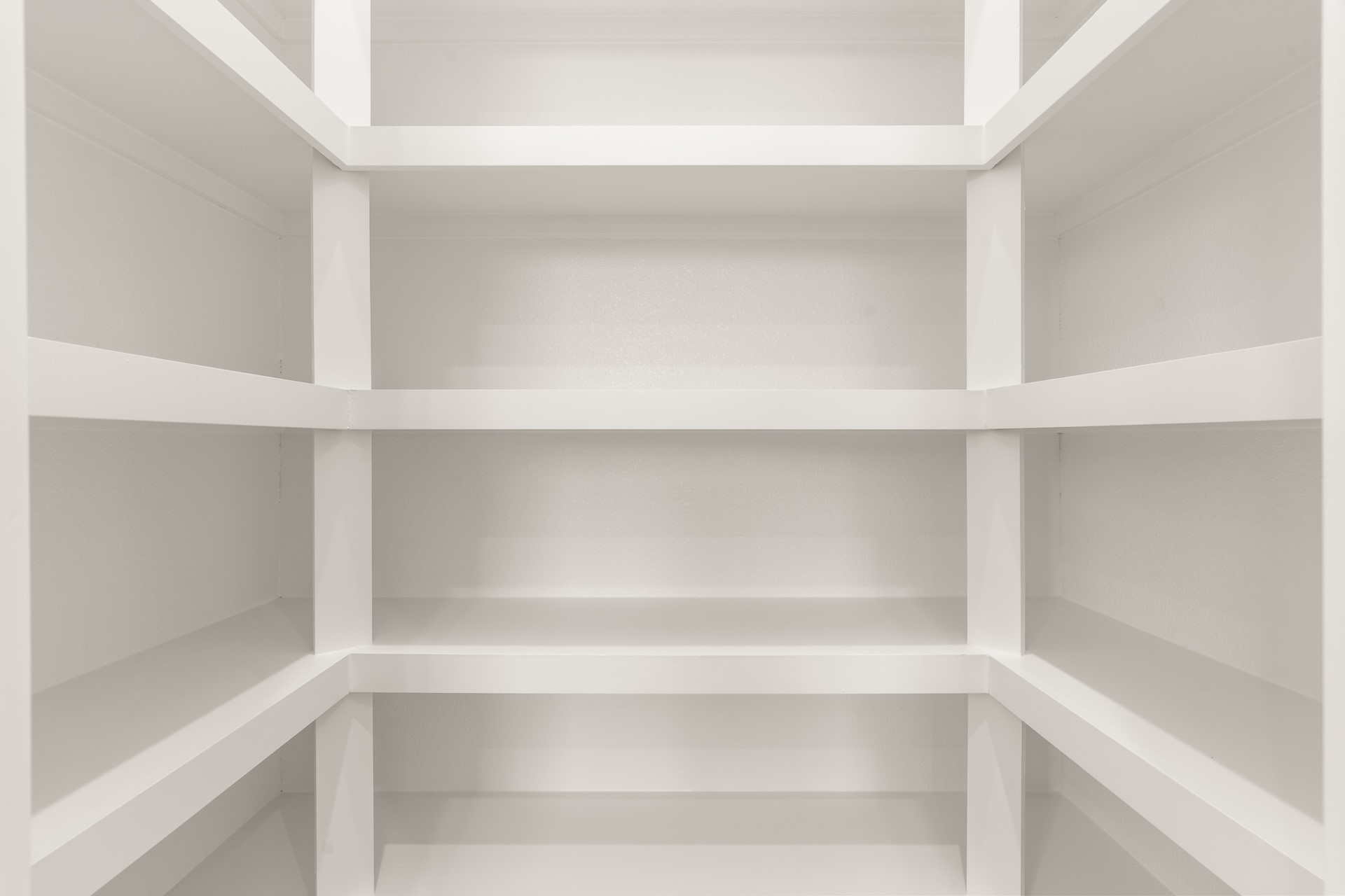 Built-in walk-in pantry shelving offering organized, generous food storage.