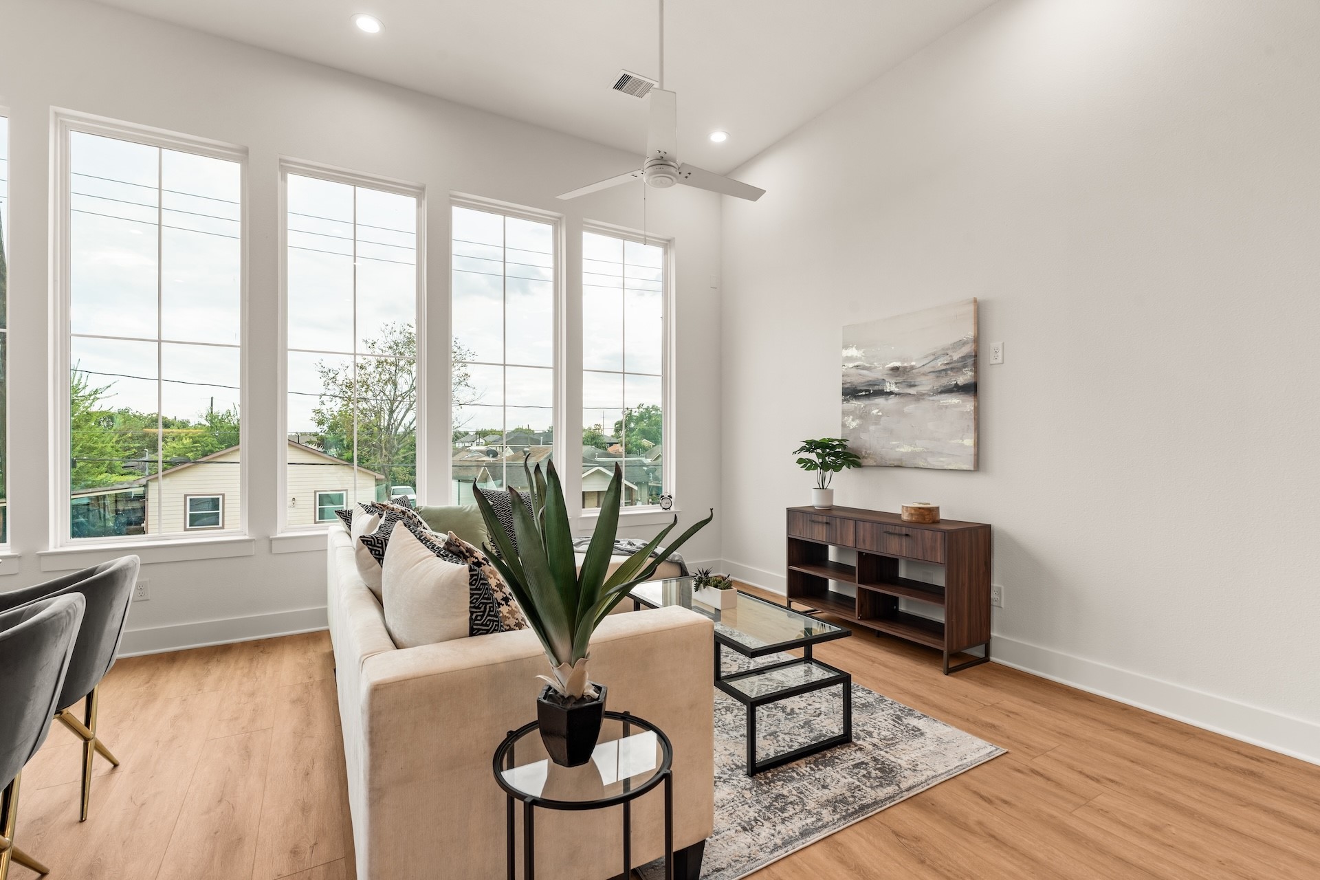 Expansive second-story living space anchored by warm wood-look flooring and soaring ceiling height.