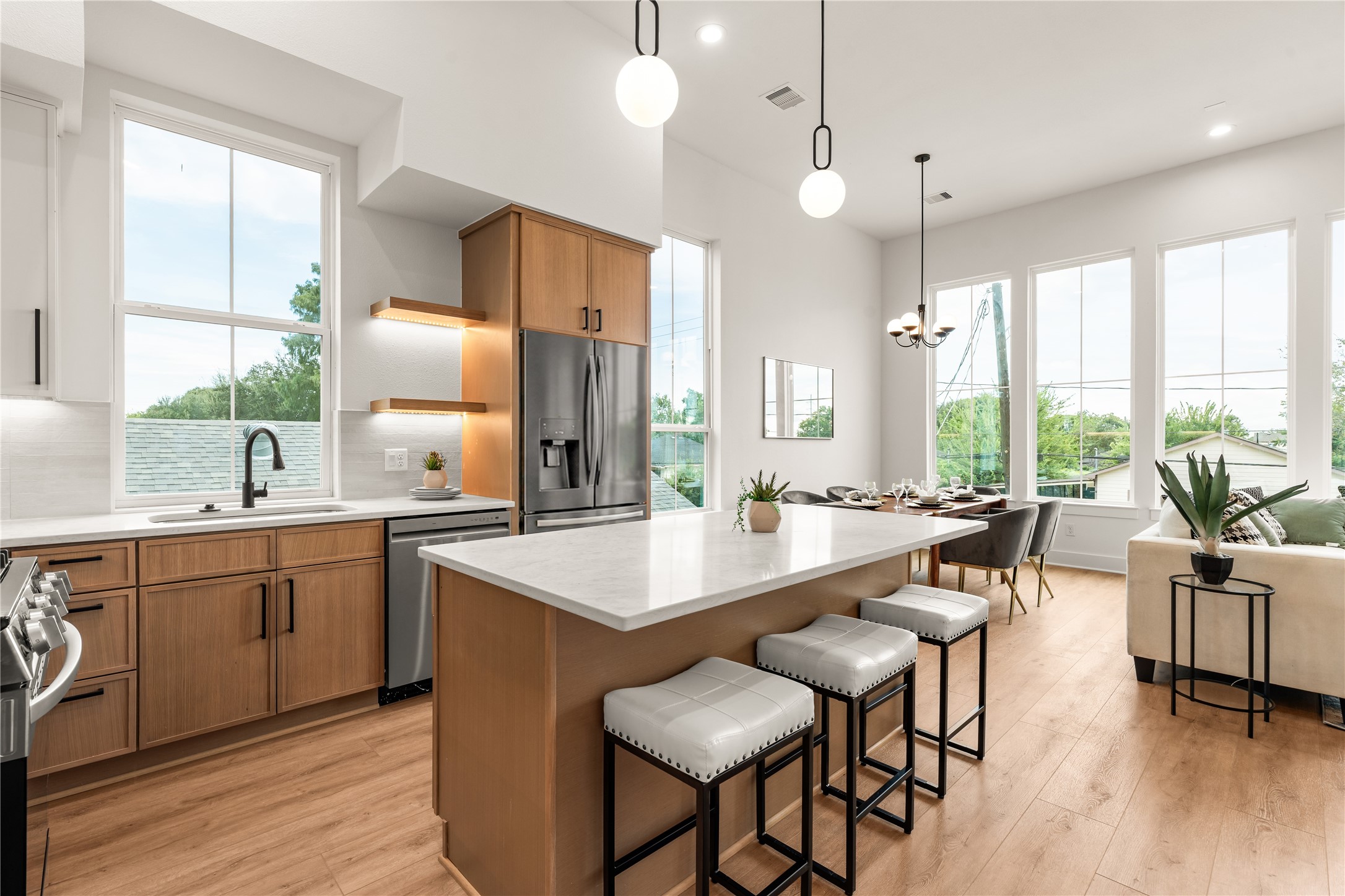 Modern kitchen workflow featuring seamless access to the open dining area and main living space.