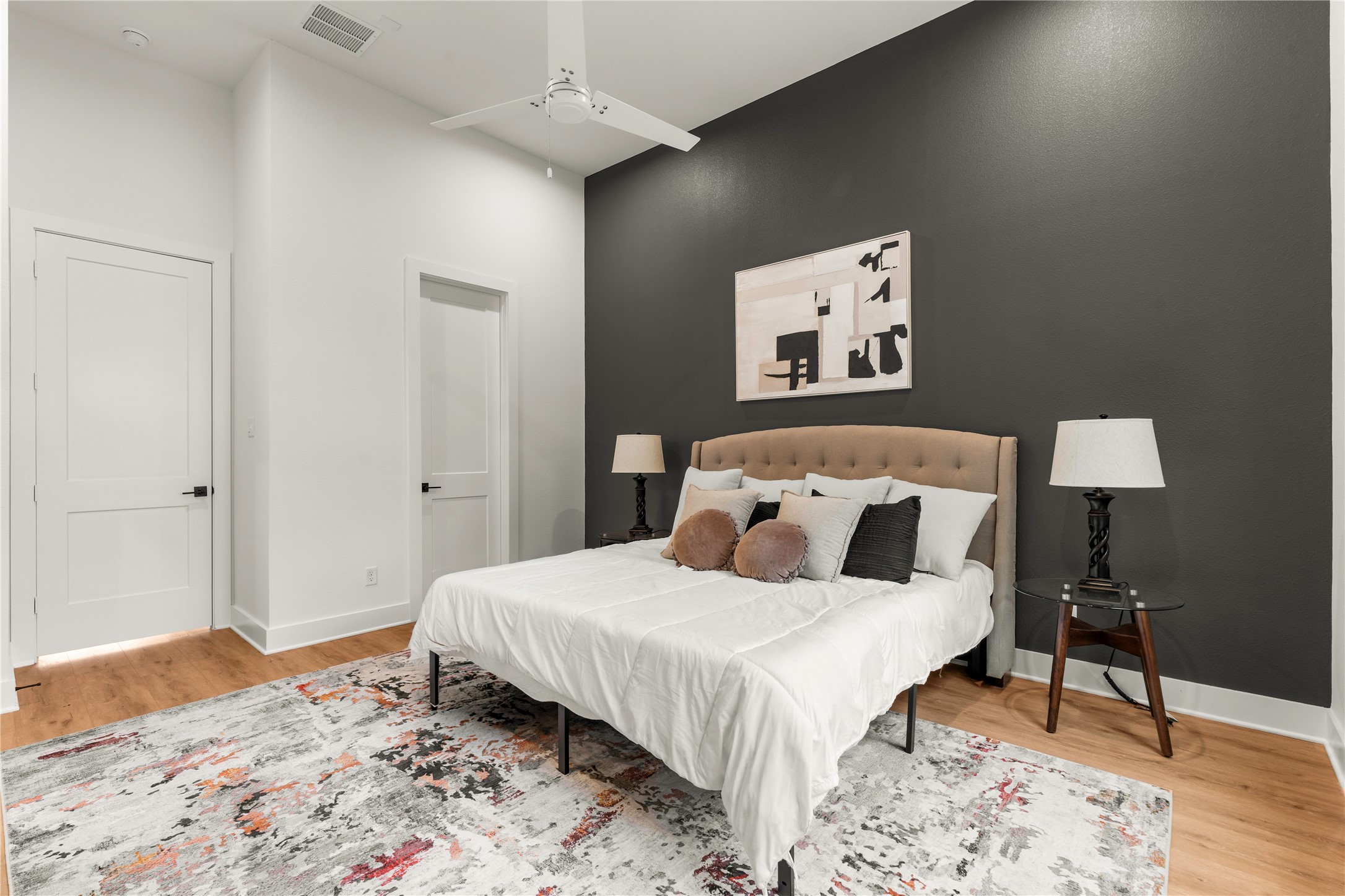 Sprawling primary suite with high ceilings and direct private access to the ensuite bath.