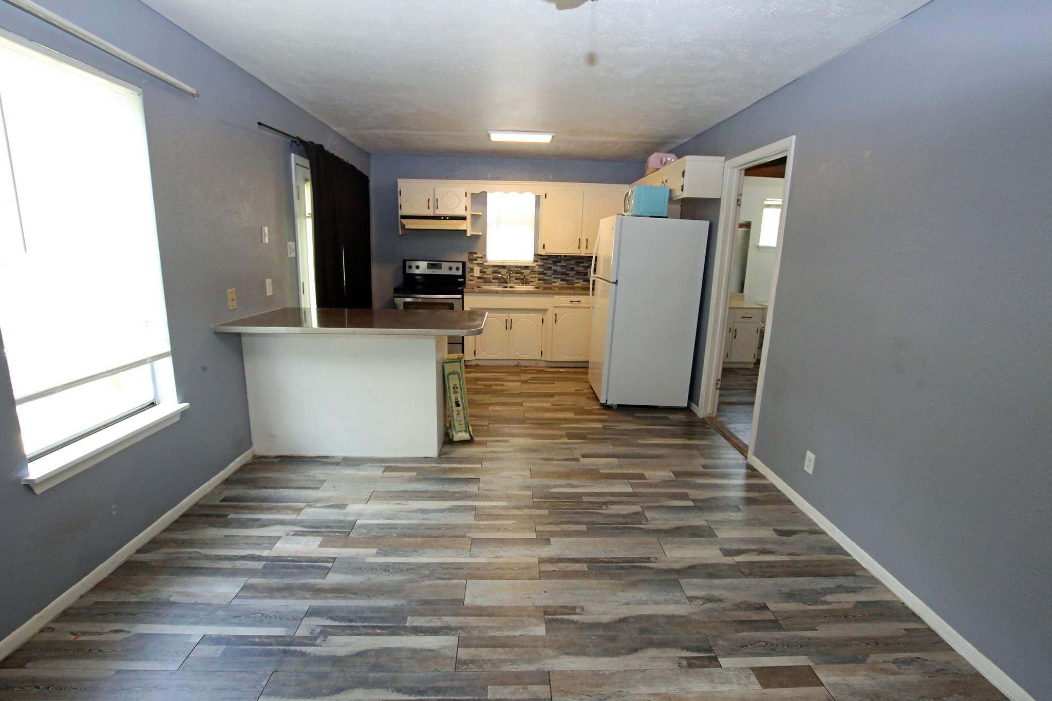 Kitchen and living room with a bar