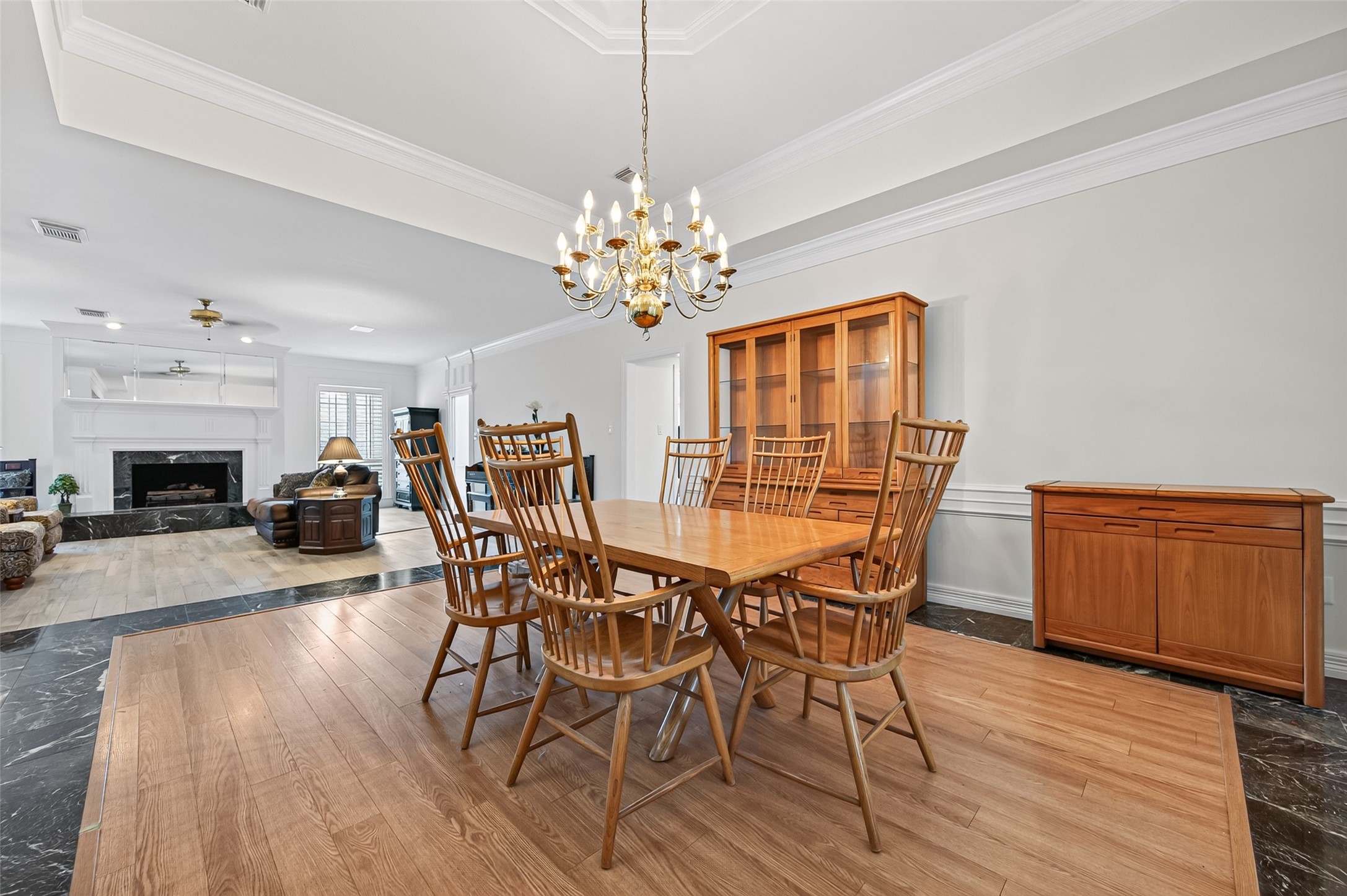 Elegant dining.  The open layout flows seamlessly into a cozy living space featuring a stylish fireplace.