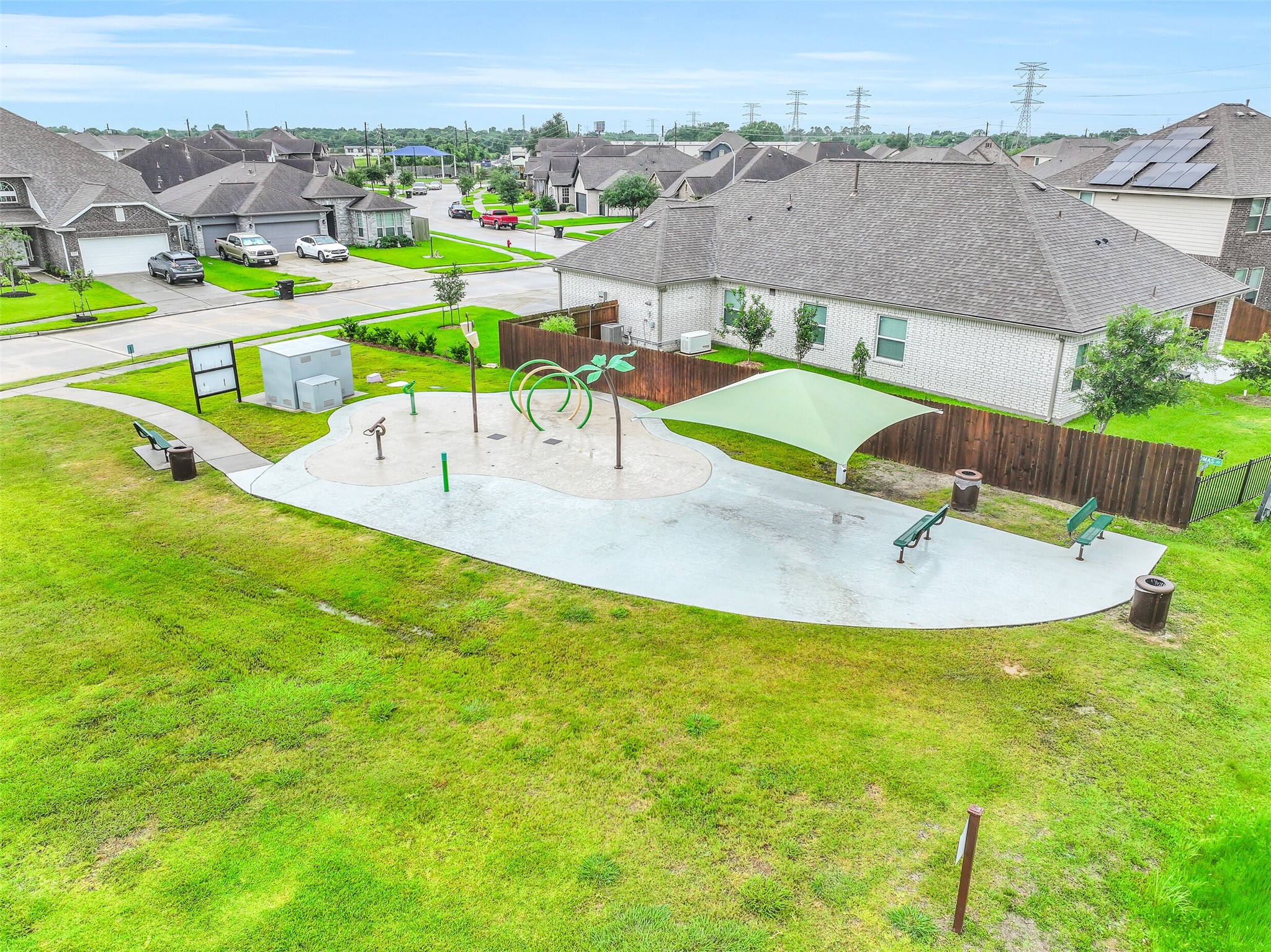 Cool off during the Texas summers at the neighborhood splash pad, featuring shaded seating areas where parents can relax while little ones play nearby.