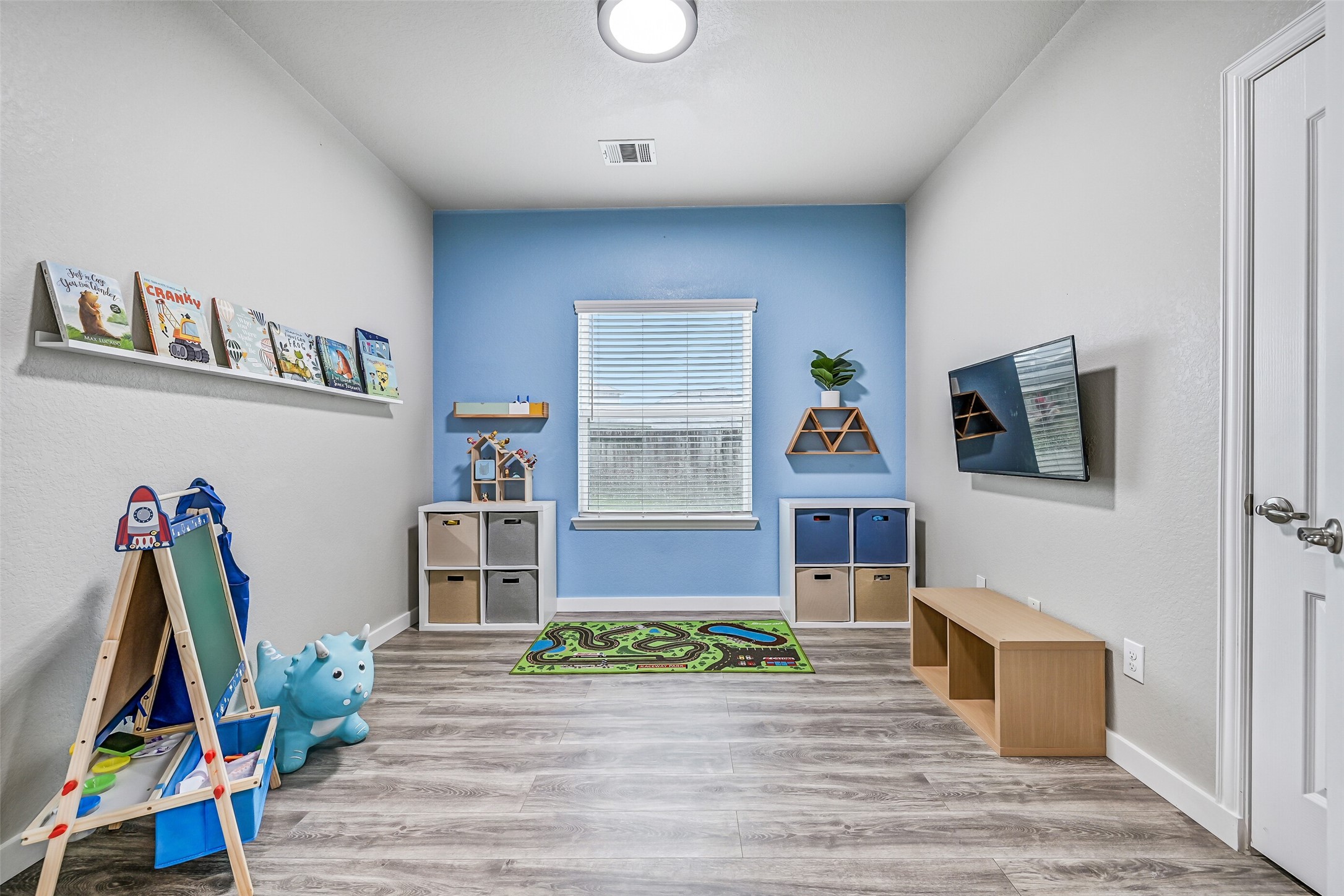 A second view highlights the flexibility of this bonus room, where abundant natural light and easy access to the nearby secondary bathroom make it equally comfortable for guests, working from home, or everyday living.