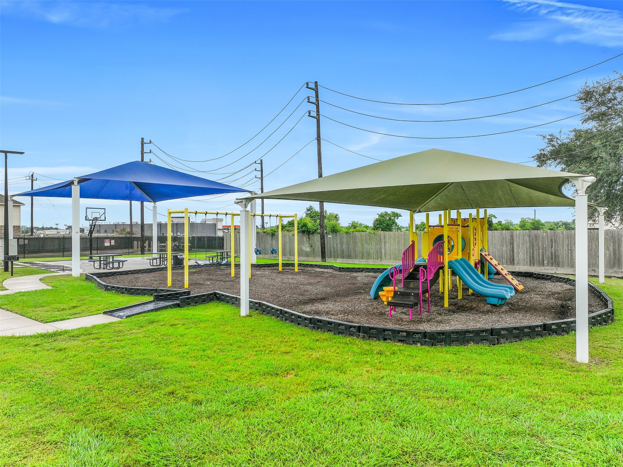 Children can enjoy hours of outdoor fun at the community playground, thoughtfully designed with shade structures to provide a comfortable place to play throughout much of the year.