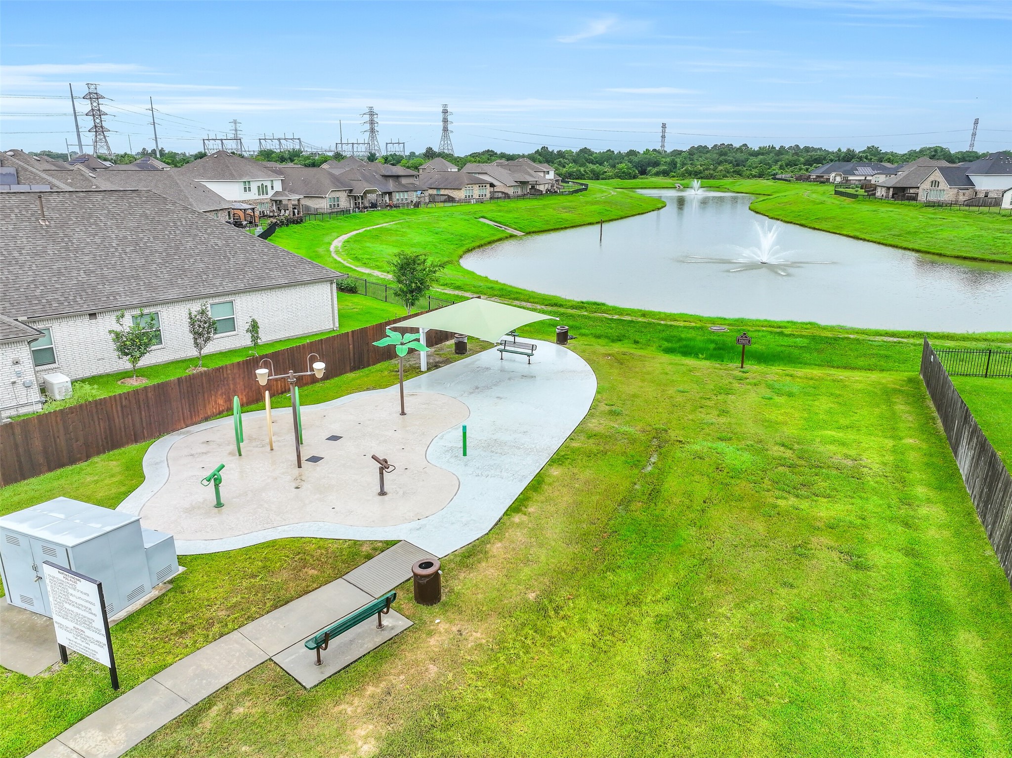 The community splash pad overlooks one of Martha's Vineyard's scenic lakes, offering a beautiful setting for outdoor recreation. Walking trails wind around the water, creating a peaceful place for morning strolls or evening walks.