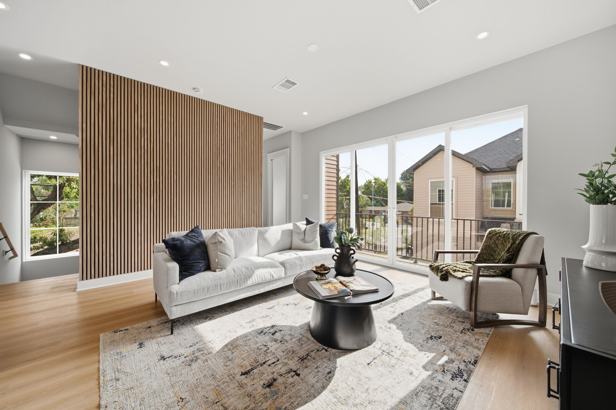 Spacious living room with decorative slat wall paneling