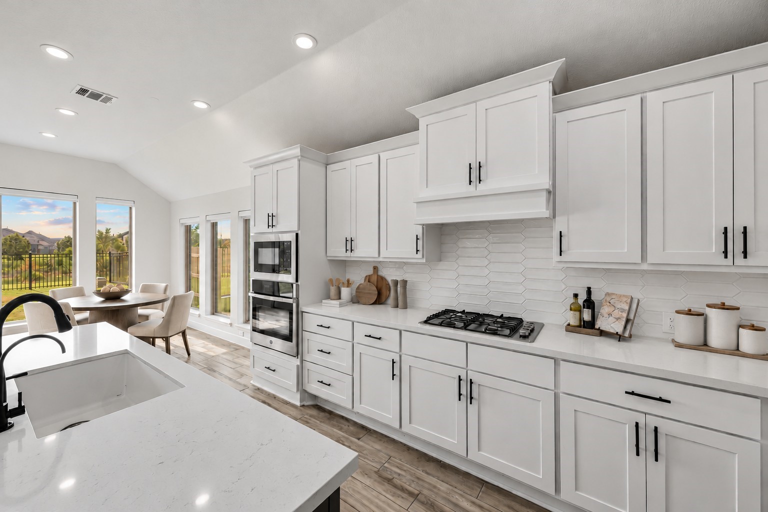 Virtually Staged: Designed with impressive spatial flow, this open kitchen features extensive solid-surface expanses and architectural tile finishes under high, sloping ceilings.