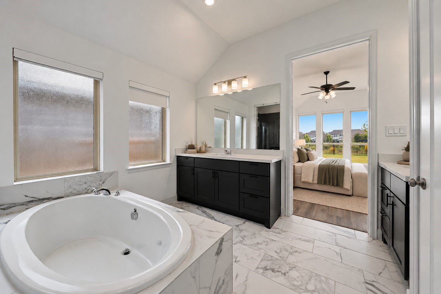 Virtually Staged: Featuring textured glass windows and continuous tile flooring, this layout effortlessly connects solid-surface vanity prep spaces with the adjoining retreat.