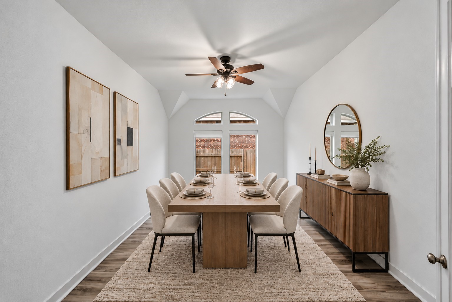 Virtually Staged: Welcome to an inviting formal dining room where dramatic cathedral ceilings and arched transom windows create an immediate impression of height and openness.