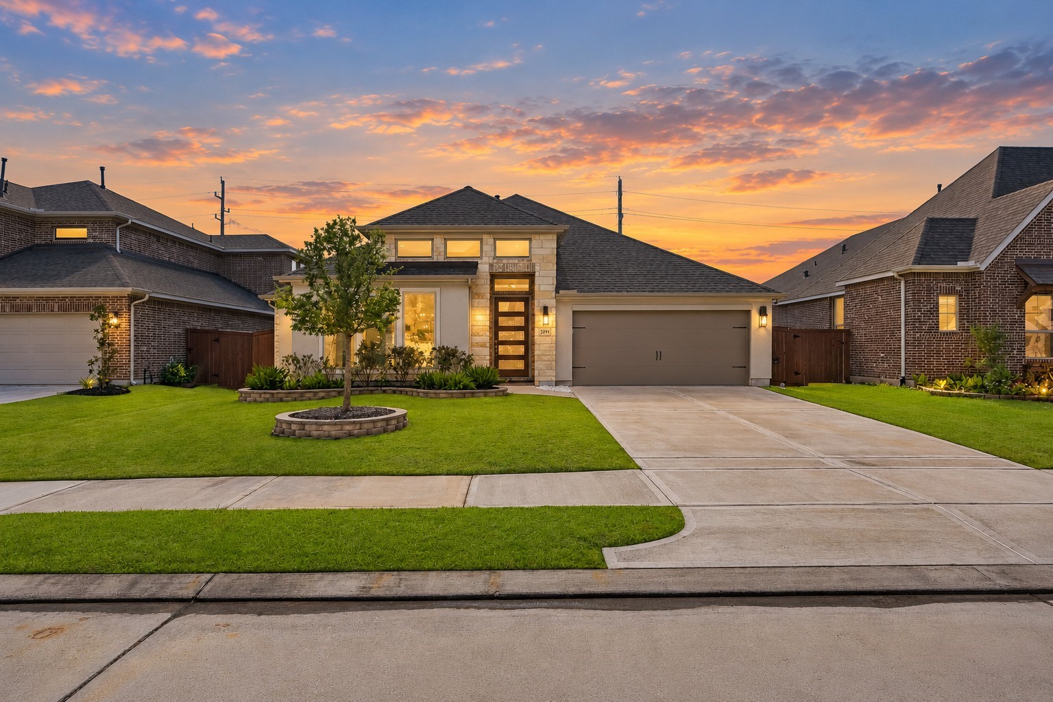 Step into refined curb appeal featuring an expansive architectural footprint, multi-pitched rooflines, and natural stone accents. Prominent exterior illumination and upper-level accent windows highlight the home's grand proportions and airy elevation.