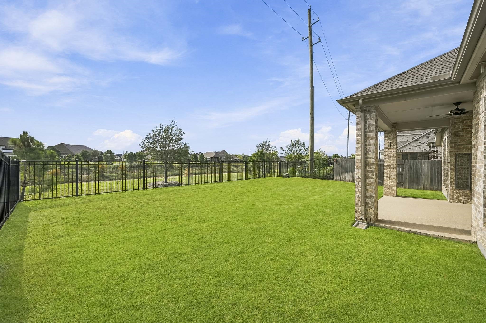 Looking across the yard toward the home, this perspective underlines the connectivity and openness of the private outdoor space.