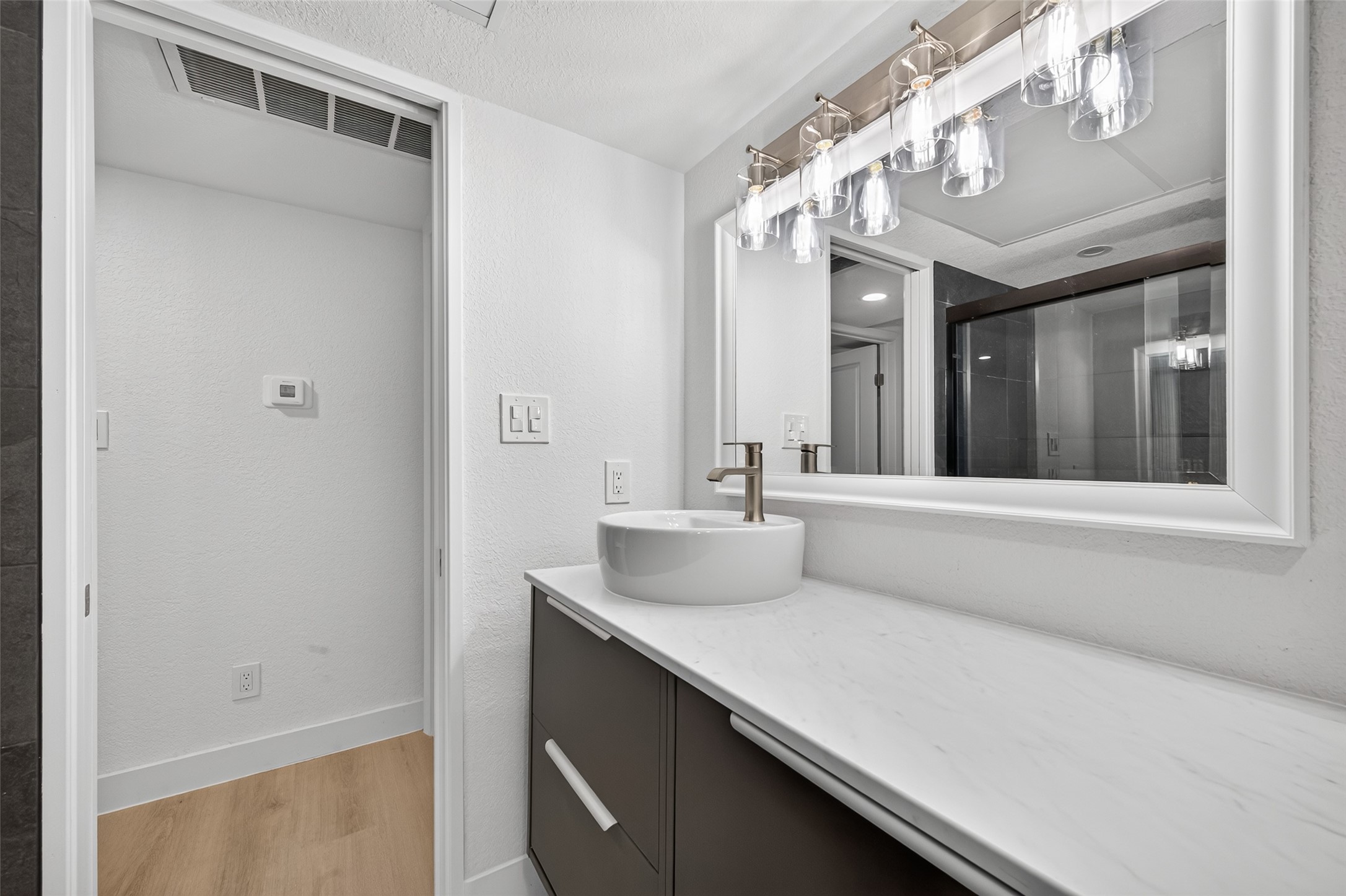 Beautifully renewed bathroom featuring updated tile, contemporary fixtures, a modern vanity, and a clean, timeless design.