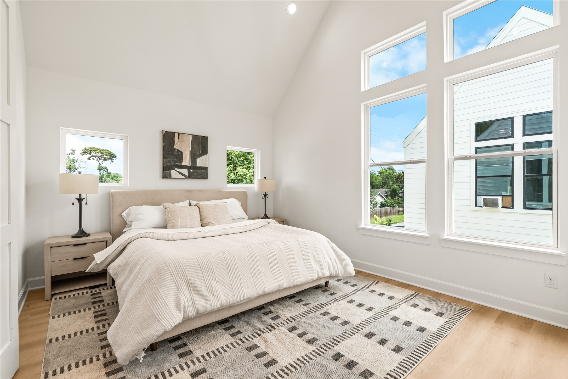Vaulted ceilings, deliberate window placement  natural light engineered into the primary suite
