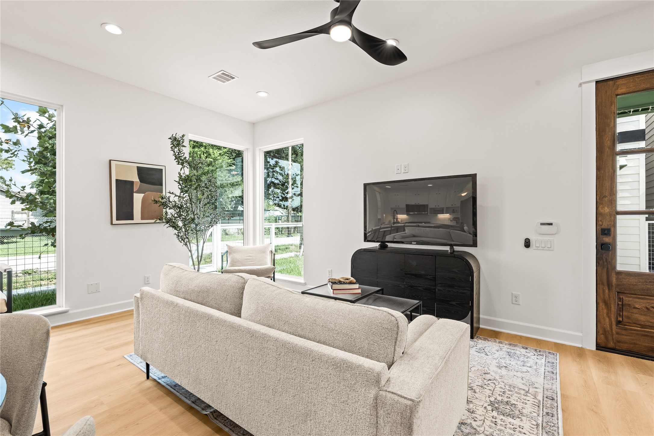 Main living volume open plan, ceiling fan, natural light drawn through floor-to-ceiling glazing Main living volume open plan, ceiling fan, natural light drawn through floor-to-ceiling glazing