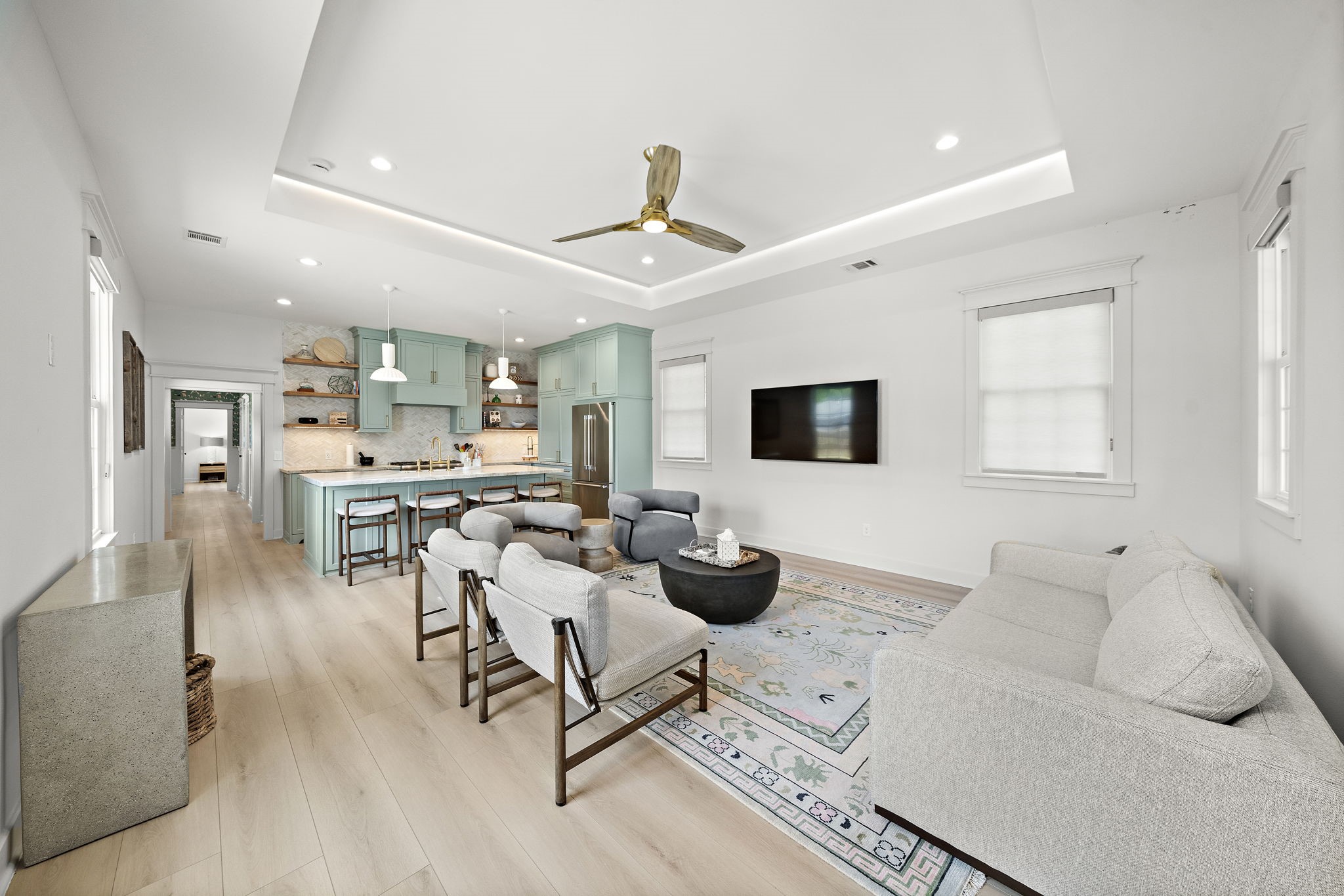 Come take a tour! As you enter through the front door, the inviting entrance flows seamlessly into the living room and kitchen.