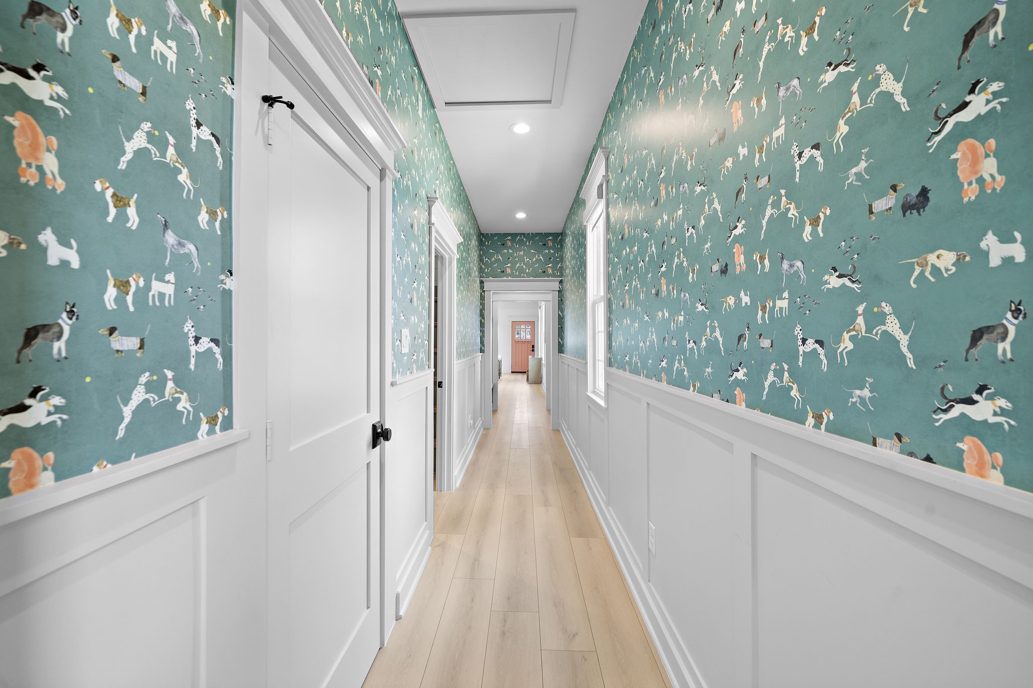Designer wallpaper in the long hall leading to the two bedrooms and laundry with built-ins.