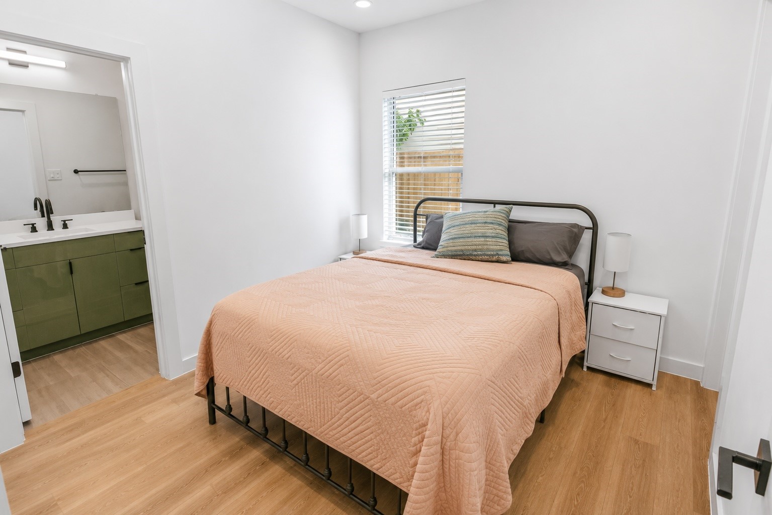 Private first floor bedroom offers a quiet retreat with warm wood look flooring, abundant natural light, and direct access to its own en suite bath. Ideal for overnight guests, a home office, or multigenerational living, the layout provides comfort and flexibility while maintaining privacy from the main living areas.