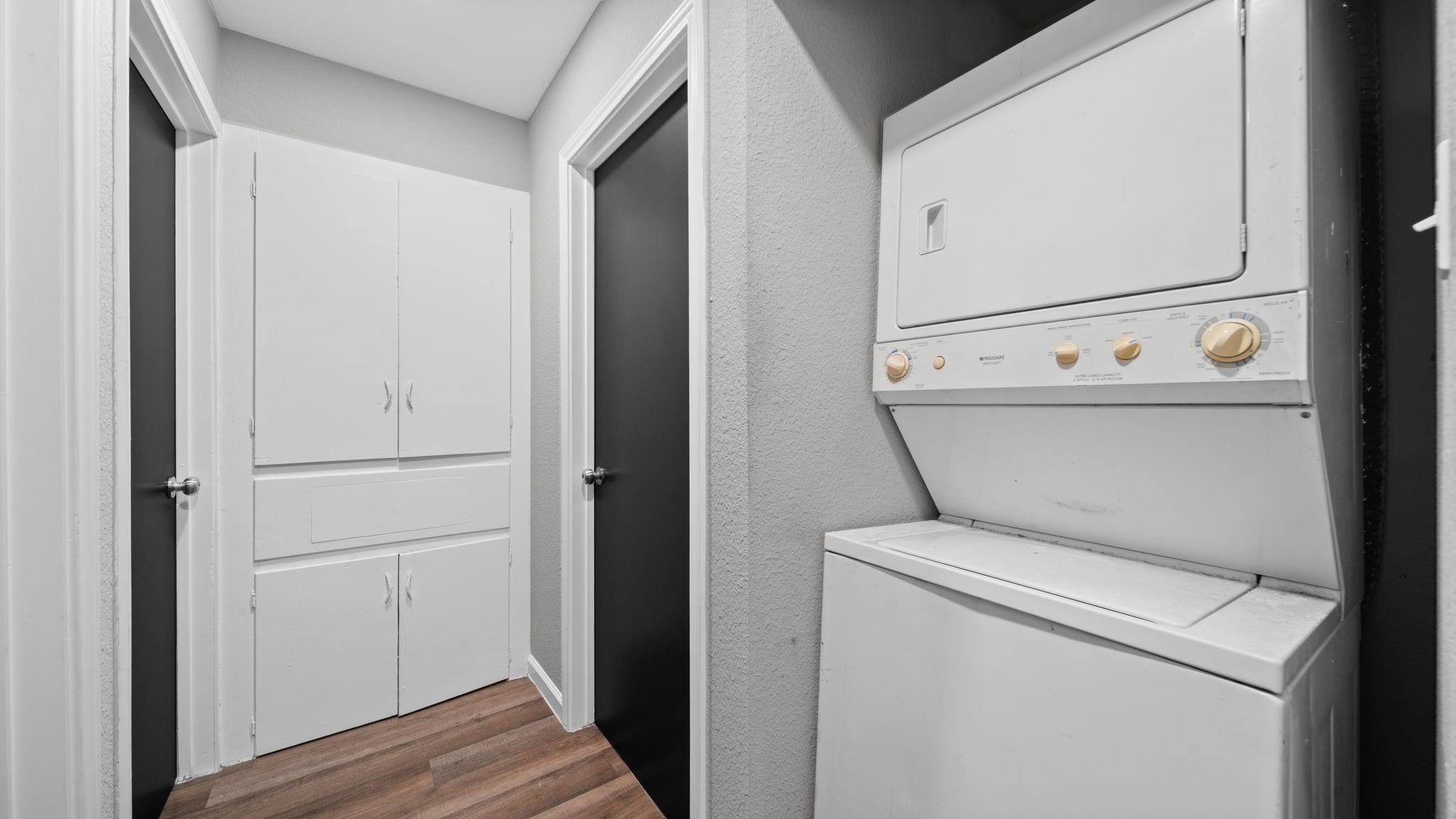 Conveniently located off the hallway, the dedicated laundry closet features a stackable Frigidaire washer and dryer, both included with the home. This well-designed space offers practical functionality while maintaining a clean, streamlined appearance.