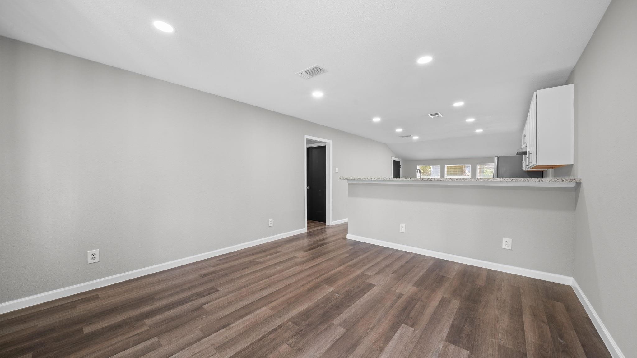 The open-concept living space showcases sleek modern lines and a sophisticated neutral palette, creating a bright, airy atmosphere with timeless appeal and endless possibilities for personal expression.