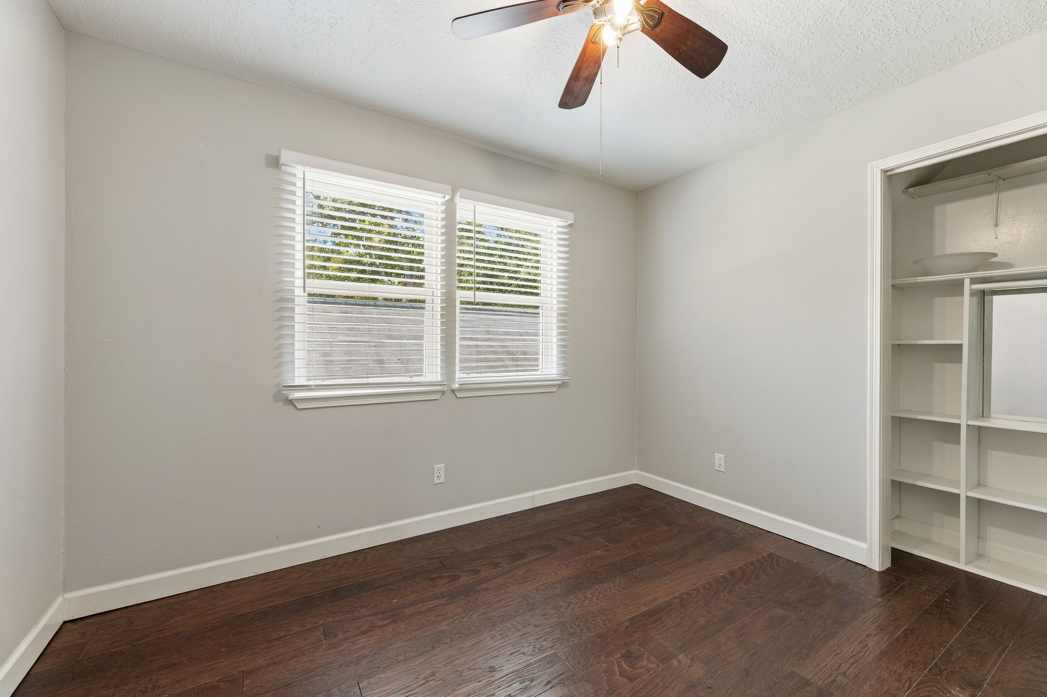 Bright secondary bedroom with ceiling fan and ample space!
