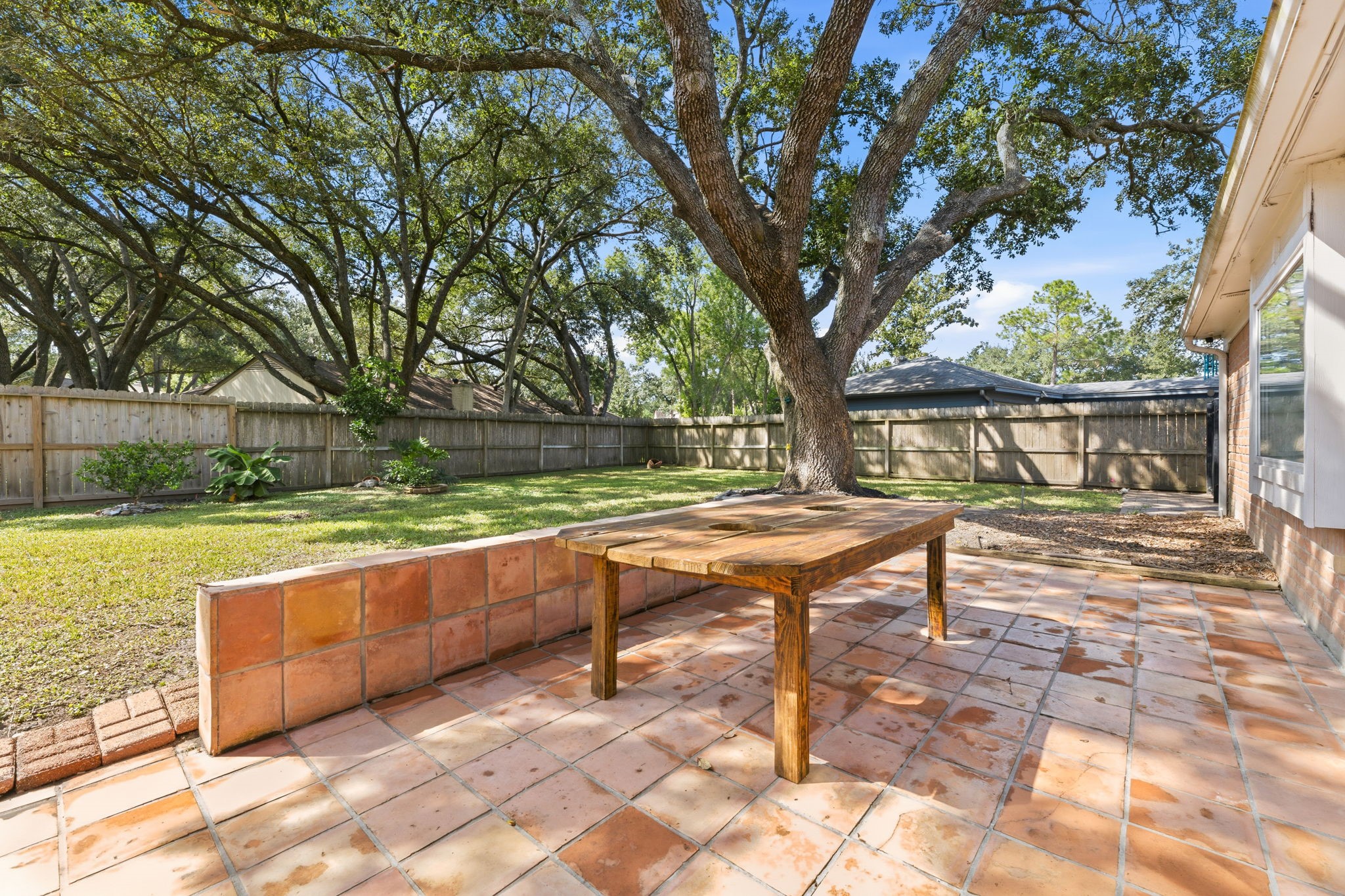 Peaceful backyard setting surrounded by mature shade tree!