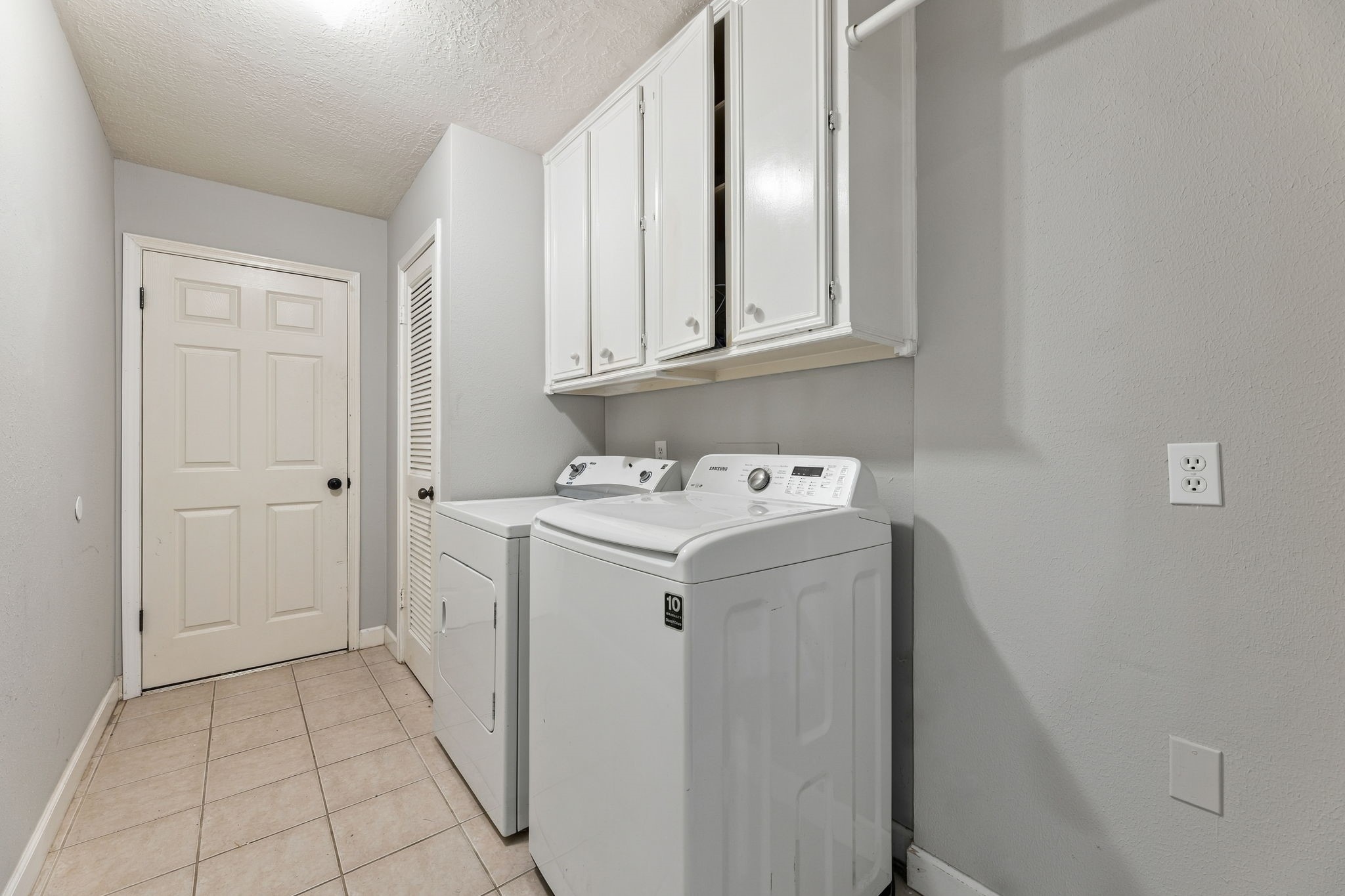 Dedicated indoor laundry room with additional storage!