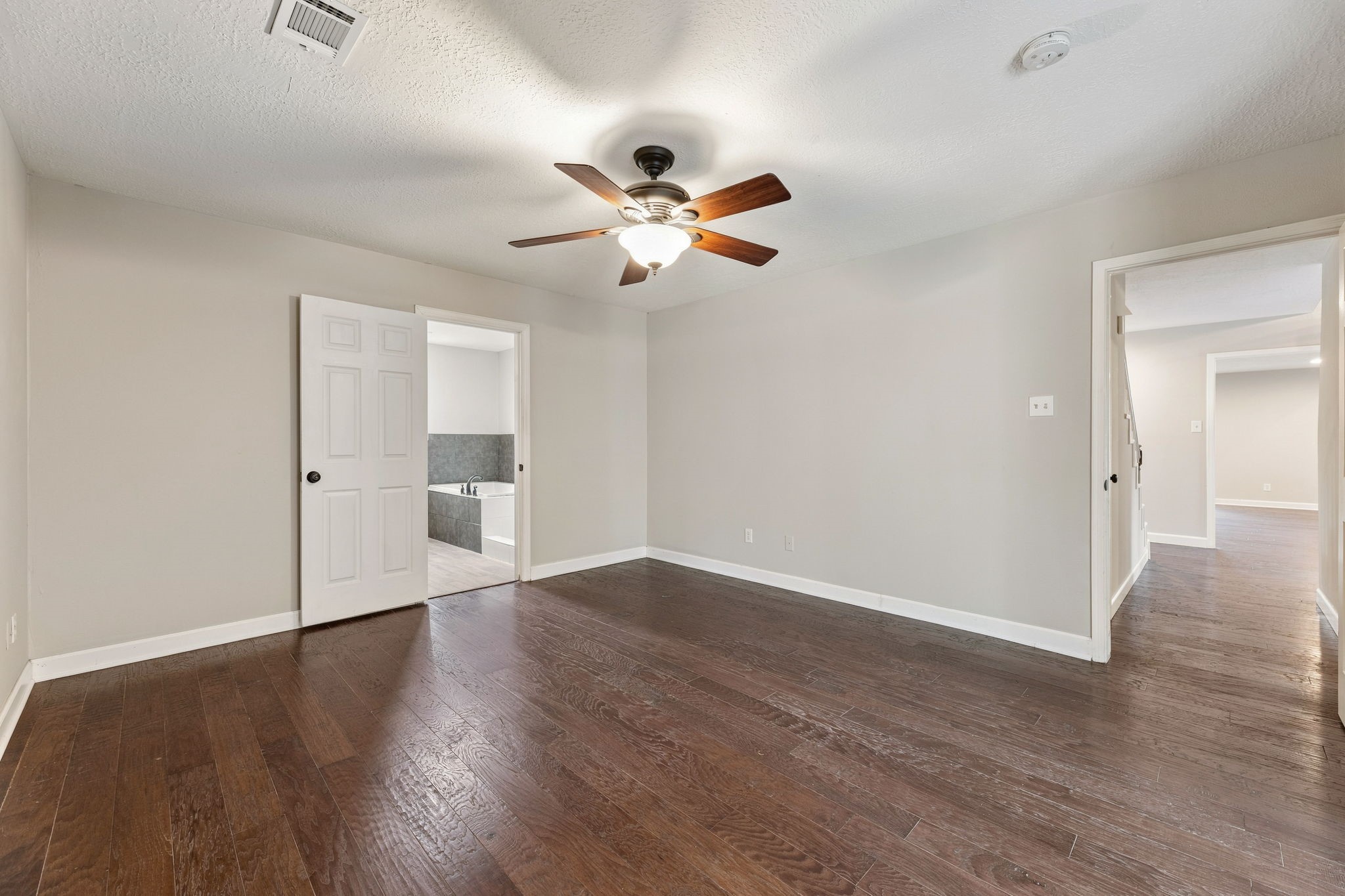 Spacious downstairs primary bedroom with wood flooring!