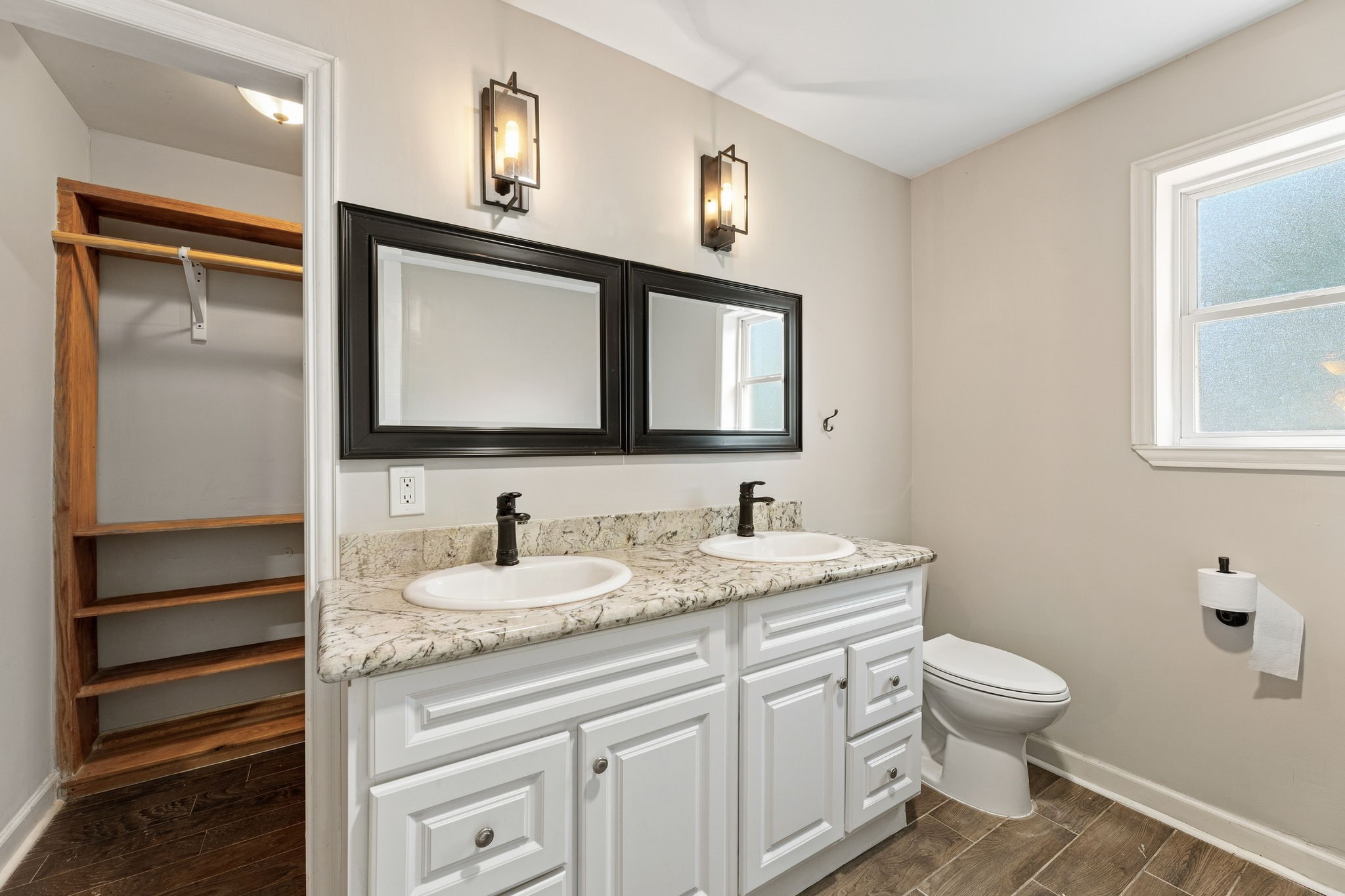 Generous primary walk-in closet with built-in shelving!