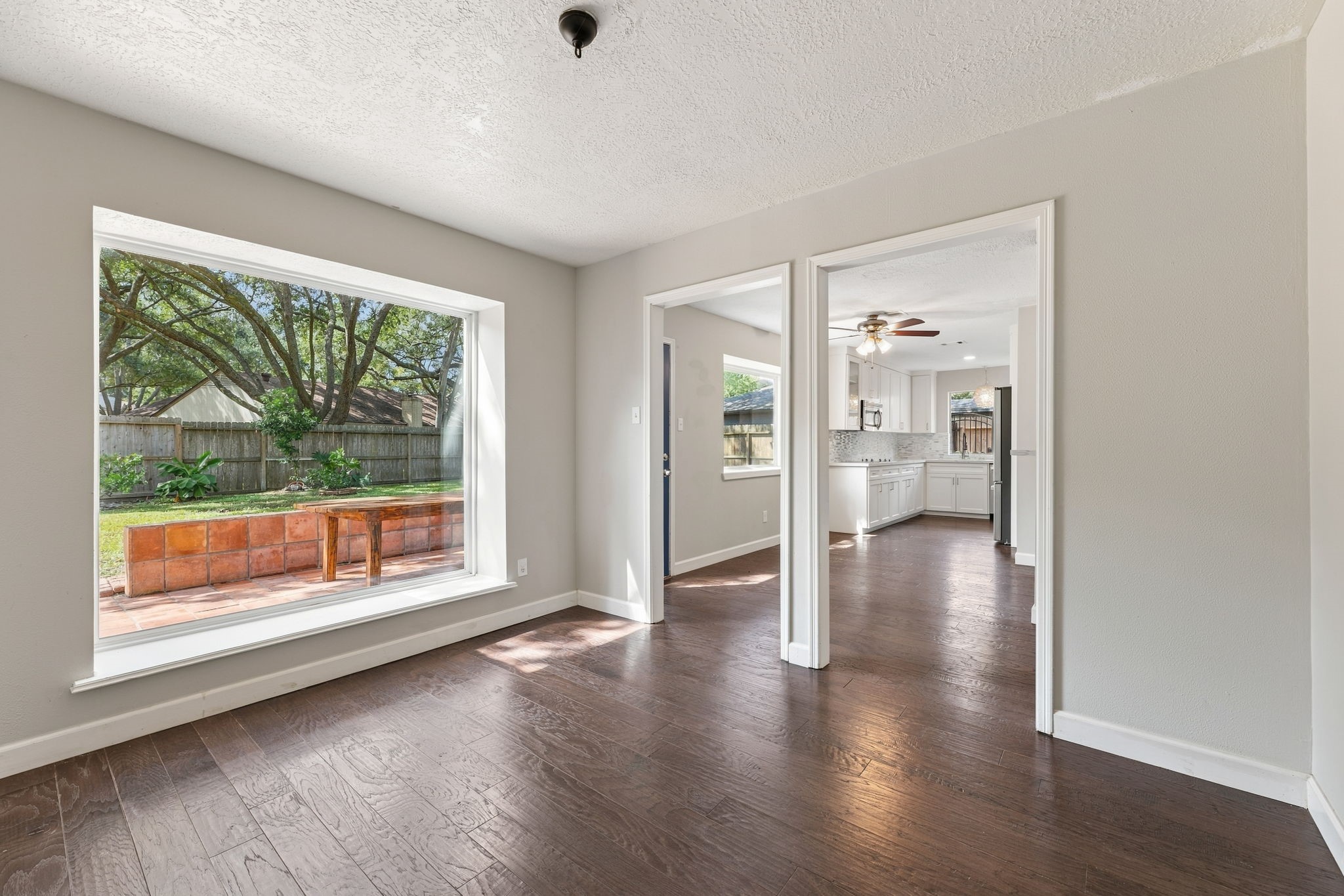 Versatile dining space with classic wall detailing and backyard views!
