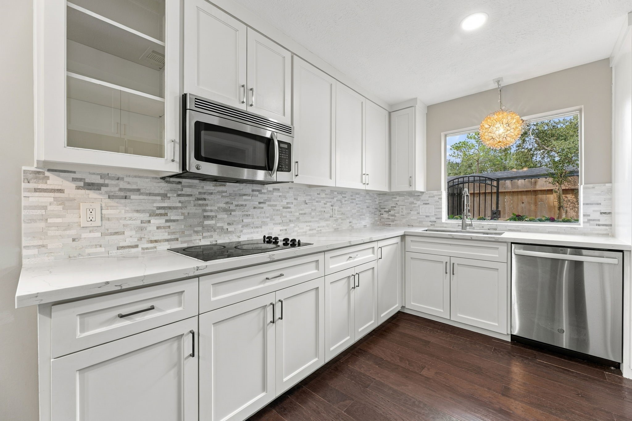Bright kitchen with shaker-style cabinetry and quartz countertops!