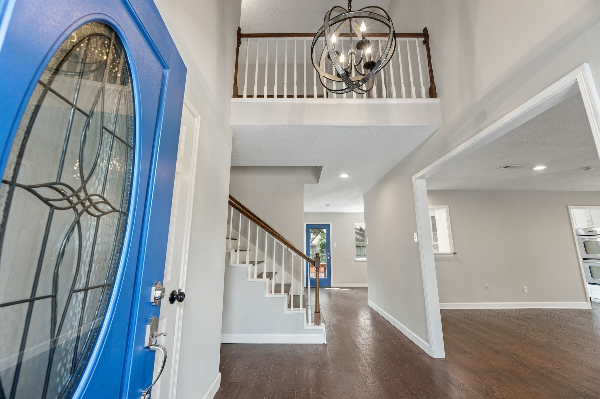 Enter and be greeted by charming chandelier and upstairs balcony!