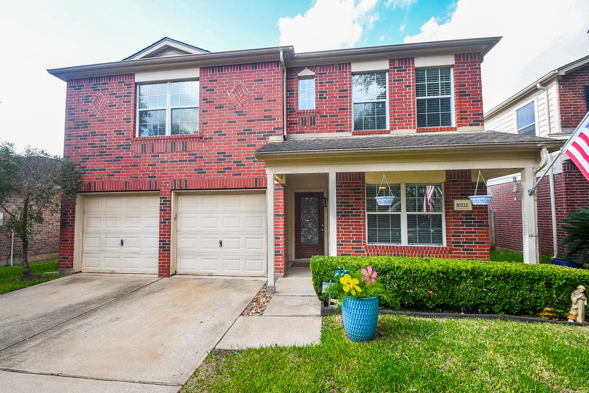 Charming two-story brick home with a welcoming front porch, dual garage doors. Charming two-story brick home with a welcoming front porch, dual garage doors.