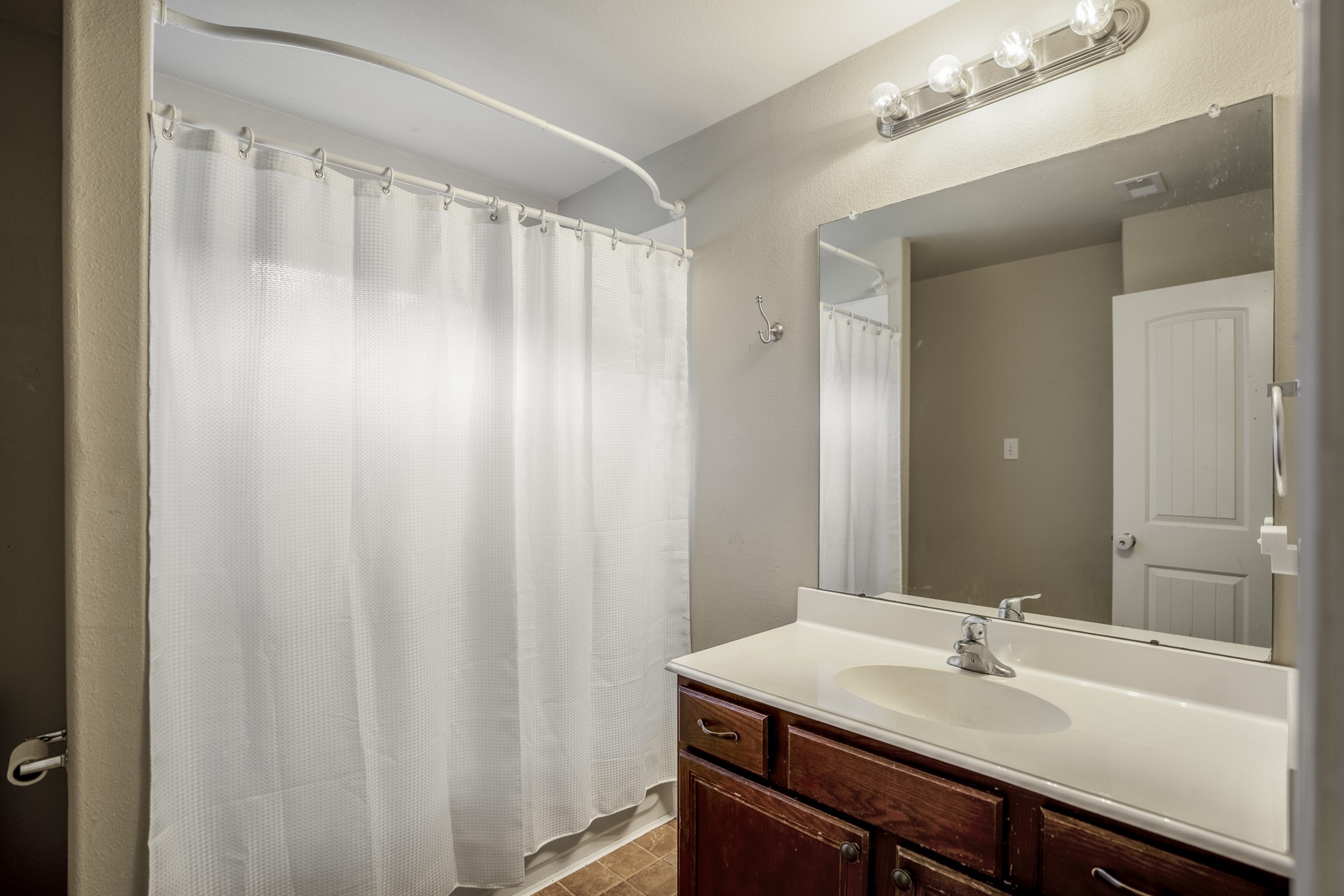 The upstairs full bath serves the secondary bedrooms with a tub/shower combination and vanity storage below. Its central location keeps morning routines and bedtime easy, with everything the upstairs bedrooms need just a few steps away.