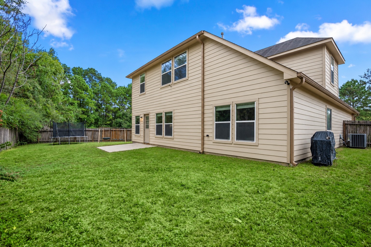 This angle shows how much potential the backyard has, with open lawn wrapping around the home and no back neighbor behind it. Theres room to imagine a larger patio setup, garden beds, play space, or just a little more outdoor livingwhile the mature trees beyond the fence keep the view feeling open and green.
