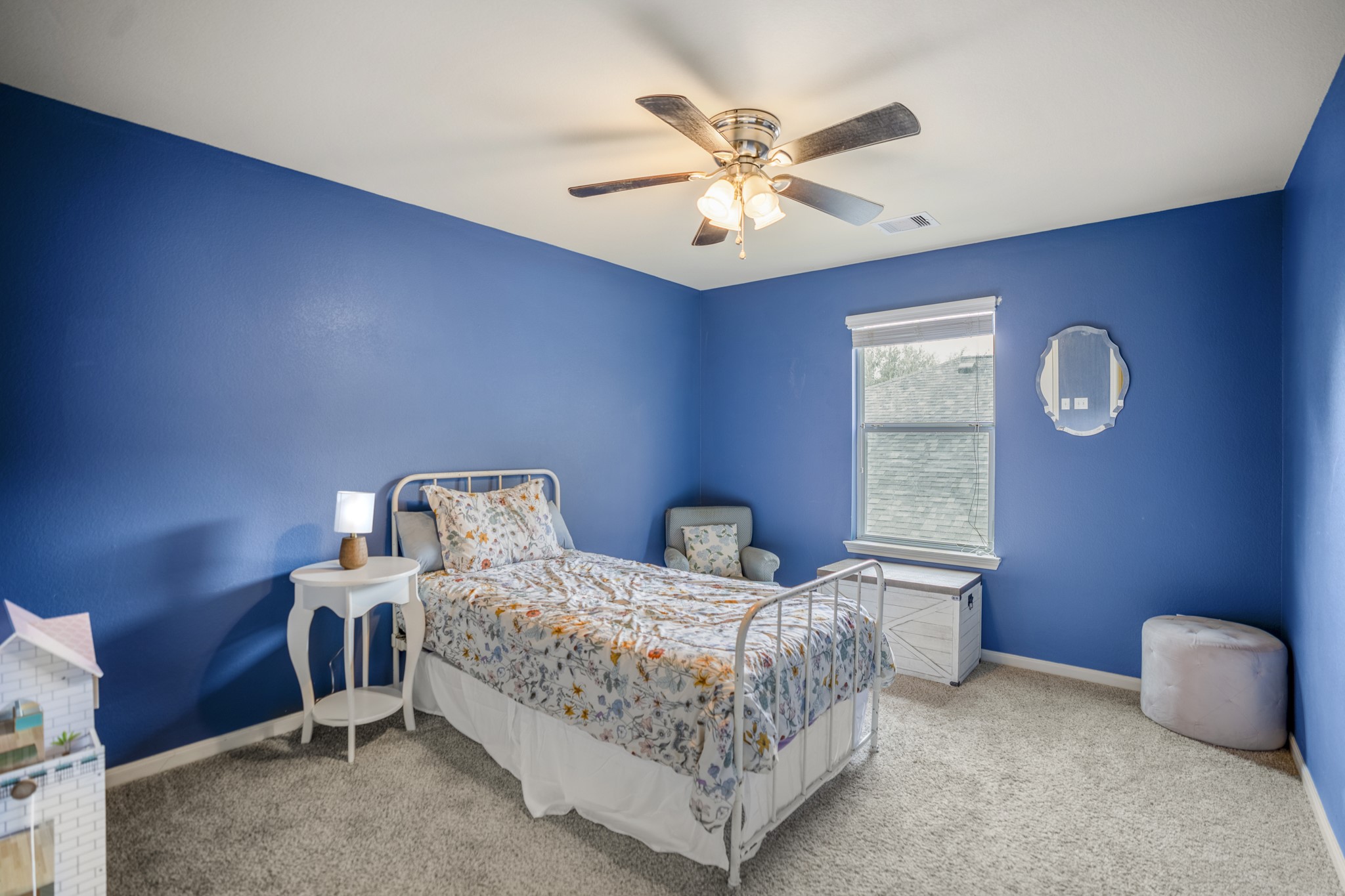Just off the gameroom, this bedroom is wrapped in bold blue walls, with a ceiling fan overhead and new carpet underfoot. One of its best surprises is the huge walk-in closet, giving this room an impressive amount of storage.