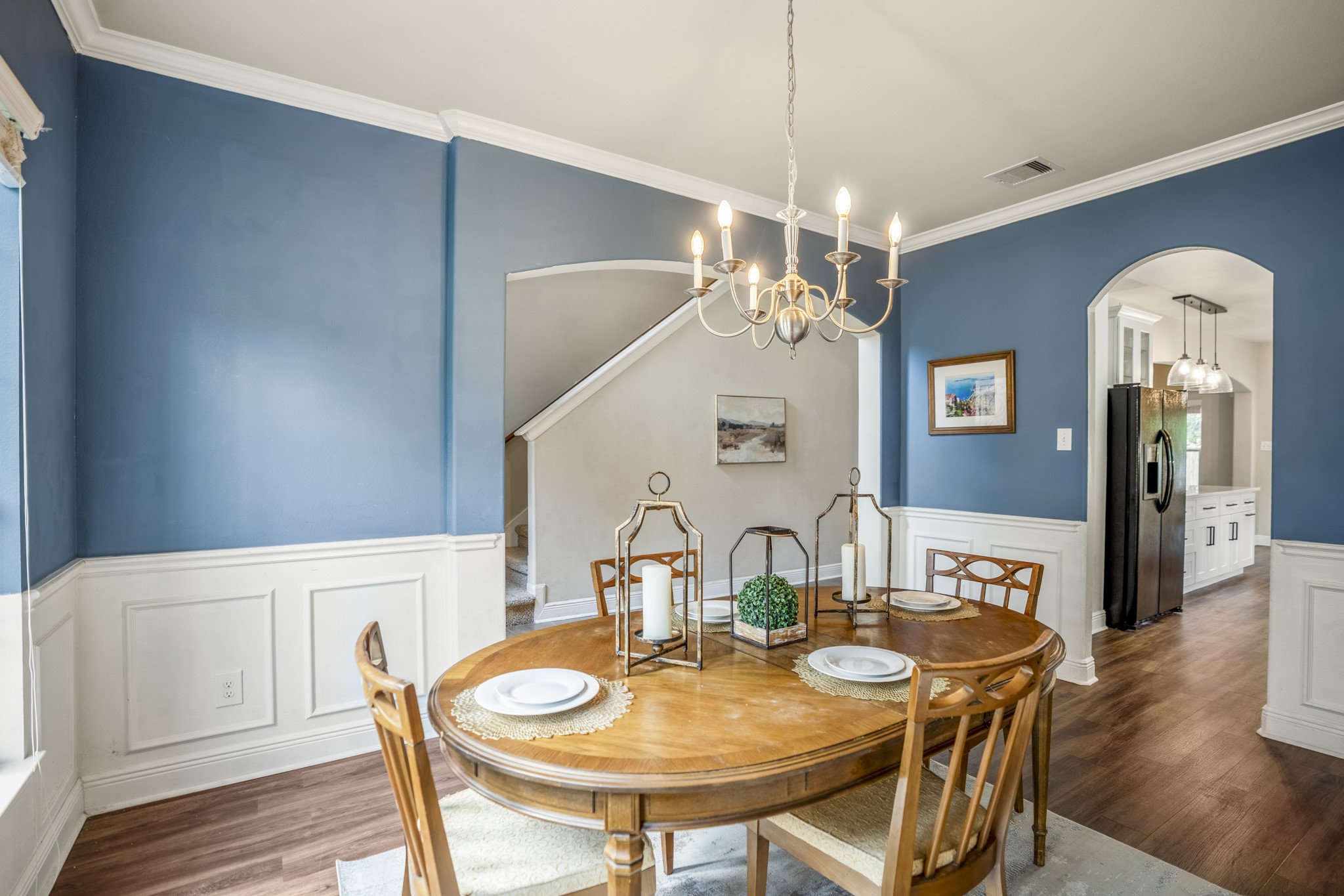 Looking back across the formal dining room, the arched opening on the right leads into the kitchen, while the larger archway across from the table opens back toward the foyer. Its an easy setup for dinners and entertaining, with the dining room positioned between the entry and the main living spaces.