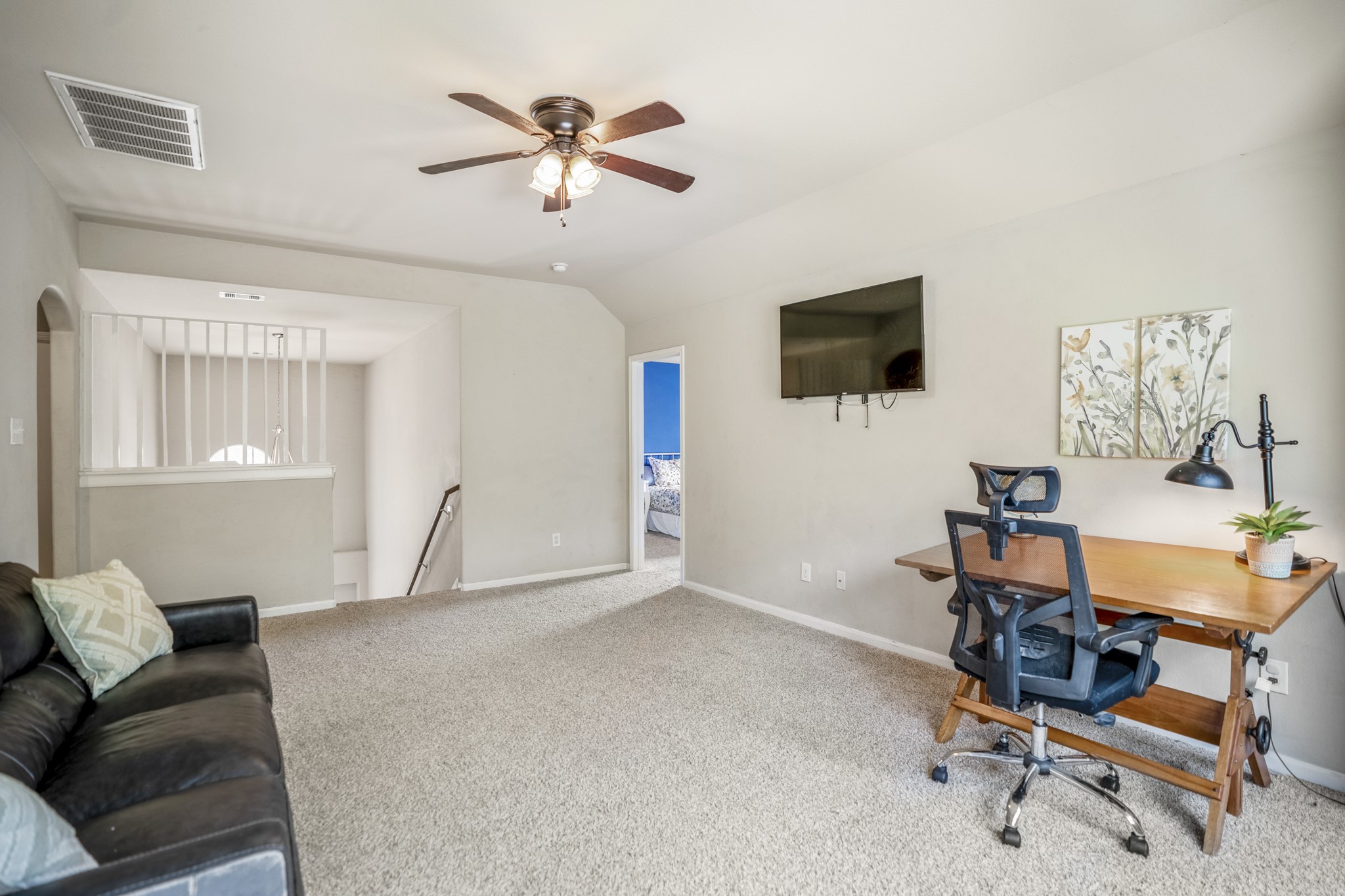 From the opposite side, the gameroom feels open and flexible, with plenty of natural light and room to spread out. The doorway on the left leads toward the secondary bedroom well visit next, while the rest of the upstairs remains just beyond.