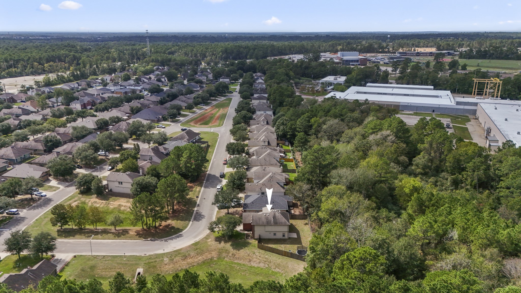 This wider aerial pulls the setting together, showing Olde Oaks surrounded by mature trees with neighborhood streets opening out toward the surrounding Willis area. Its a nice reminder that home life here can feel a little more removed, while Lake Conroe, shopping, dining, and I-45 are still within easy reach.