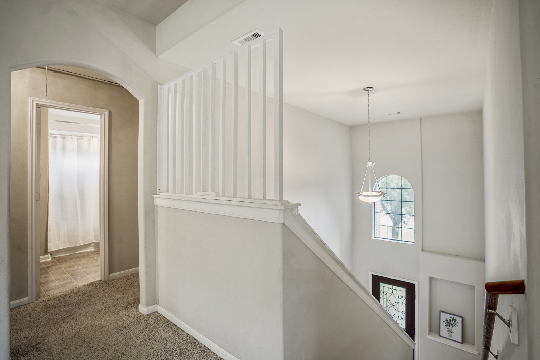 Back in the gameroom/loft at the top of the stairs, the open railing keeps the foyer visible below and gives you a better sense of how the two levels connect. Across the gameroom, the upstairs full bath is just steps from the bedrooms, keeping the second floor easy to navigate.