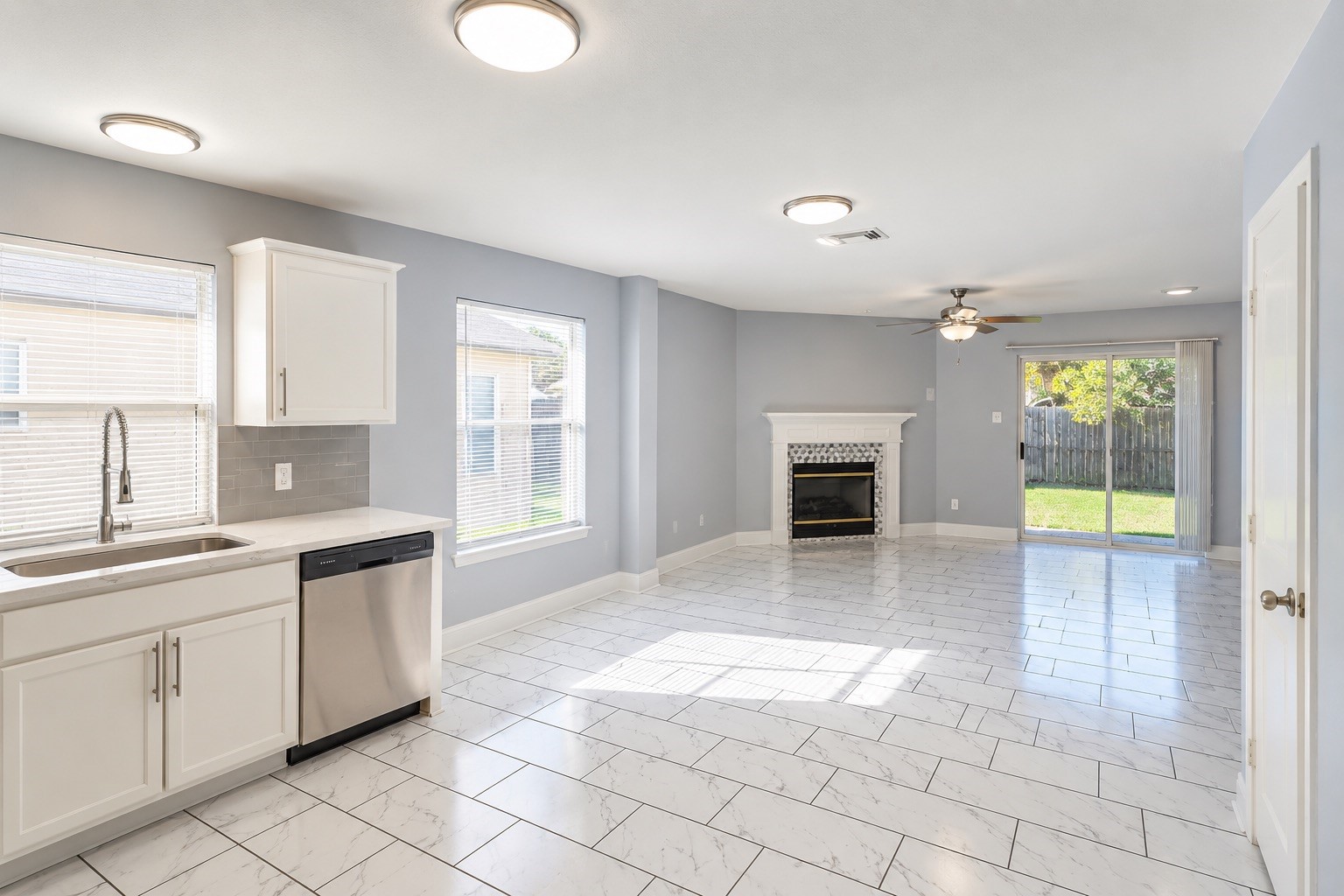 Spacious Layout with Cozy Fireplace & Backyard Access