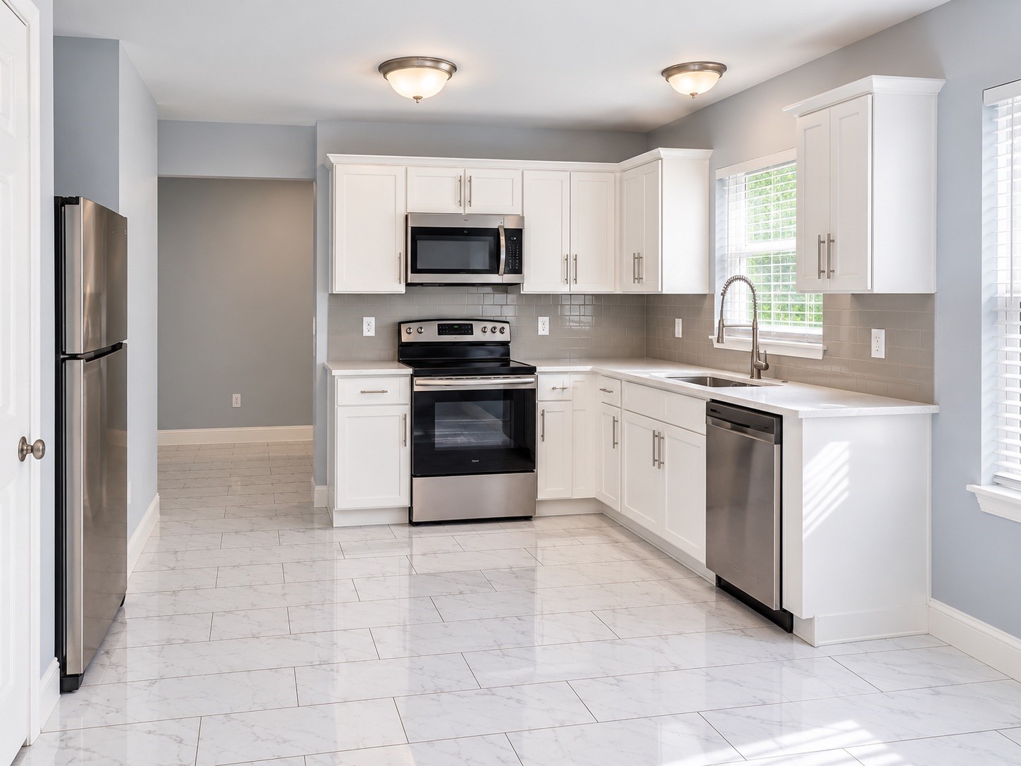 Kitchen | Beautifully Remodeled with Quartz Countertops, White Shaker Cabinets & Stainless Steel Appliances
