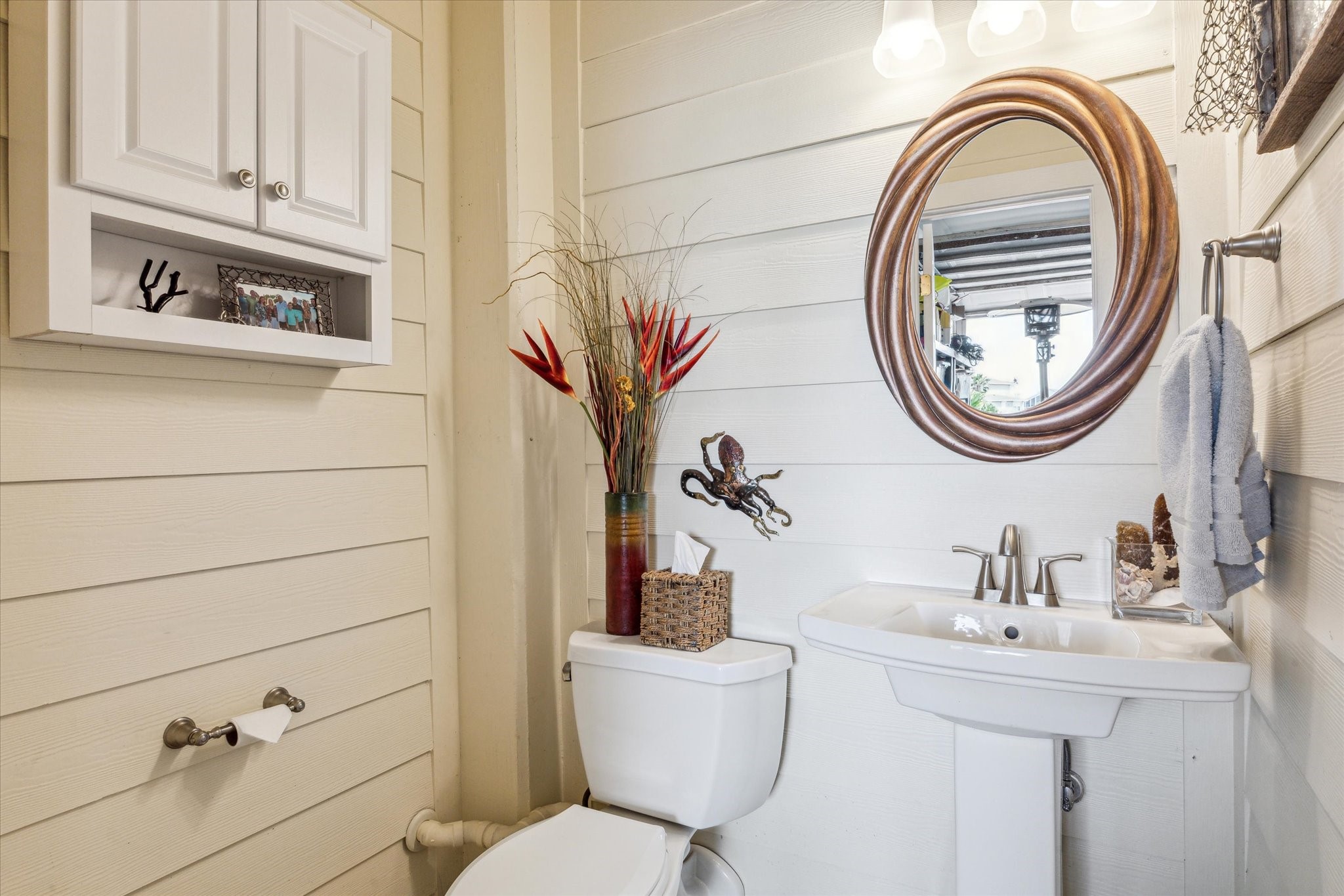 This half bathroom was added inside one of the 4 garage stalls so that you won't have to go upstairs while enjoying the pool or outdoors.