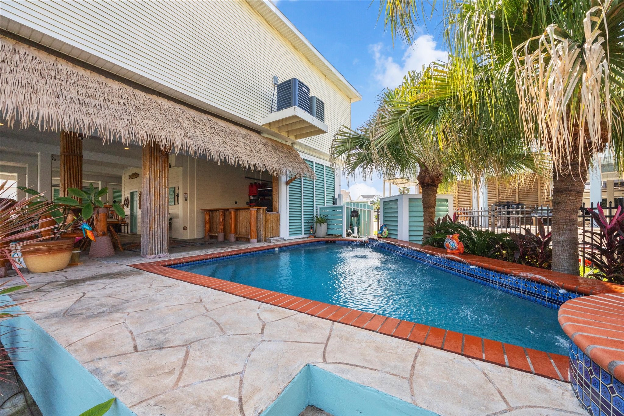 This outdoor space is hard to beat! The heated pool next to the palapa and tiki bar is just one of the spaces to enjoy outside at 102 Bamaku Bend.
