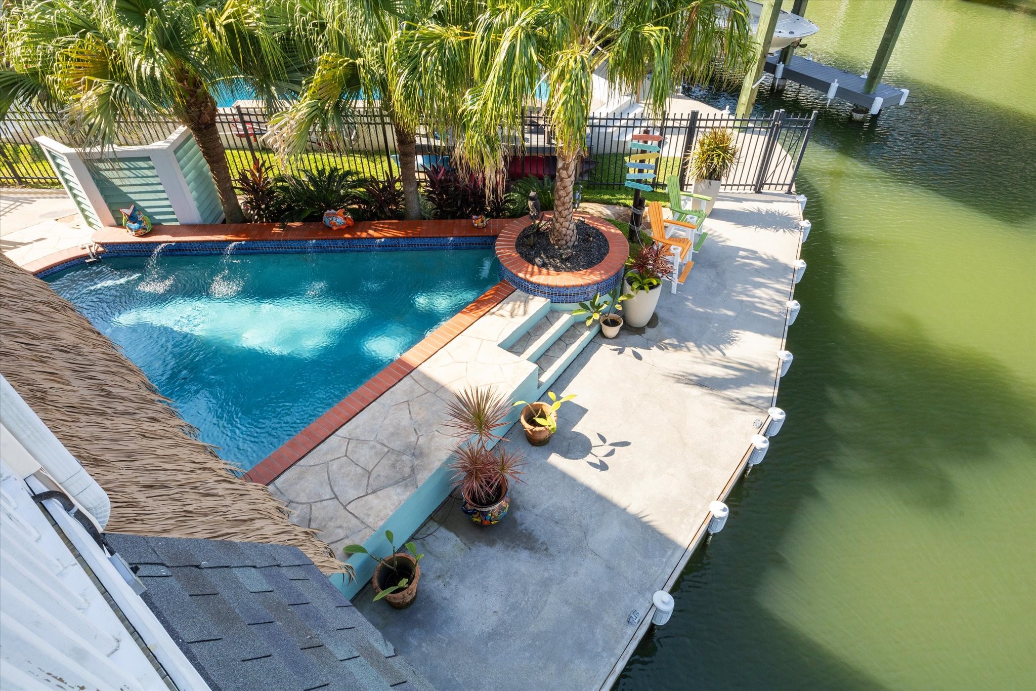 This view from your second level deck shows the corner pool overlooking the canal, along with an additional seating area along the 118' of concrete bulkhead. There is plenty of boat parking if you need more than your 2 boat slips and multiple outdoor areas to enjoy!