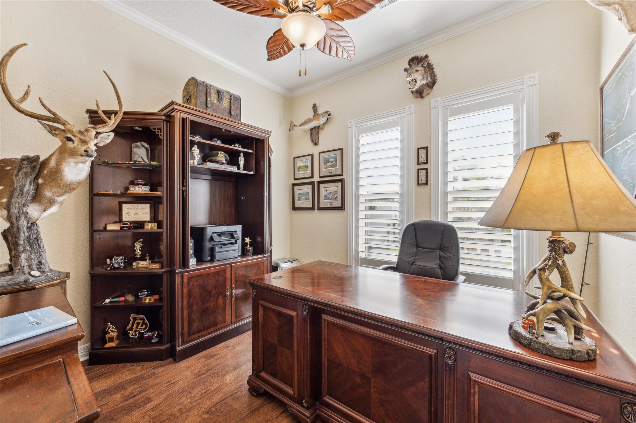 Tucked away in the corner of the home just off of the kitchen, dining and living areas is this room that makes the perfect home office or bedroom if needed. Beautiful wood floors, crown molding and detailed trim around the windows elevate this room.