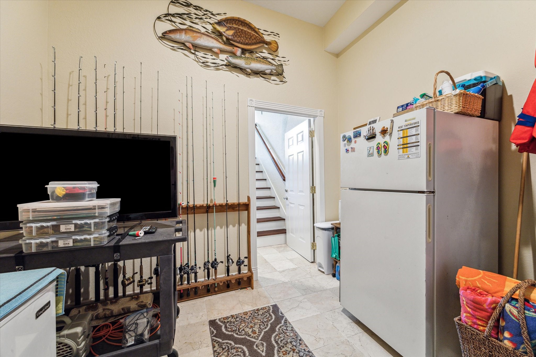 As you head down stairs you have a large storage room under the stairs, access into the garage and this room which offers a great space to store all of your fishing and water sport toys and supplies.