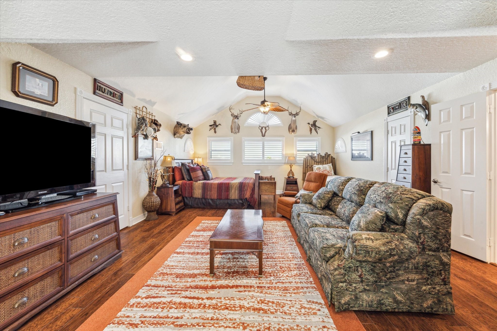 At the top of the stairs is this large flex space currently being used as a guest bedroom and hangout space. It features a full sized bathroom and large custom walk-in closet and could easily make an additional bedroom, gameroom, office or craftroom depending on your needs.