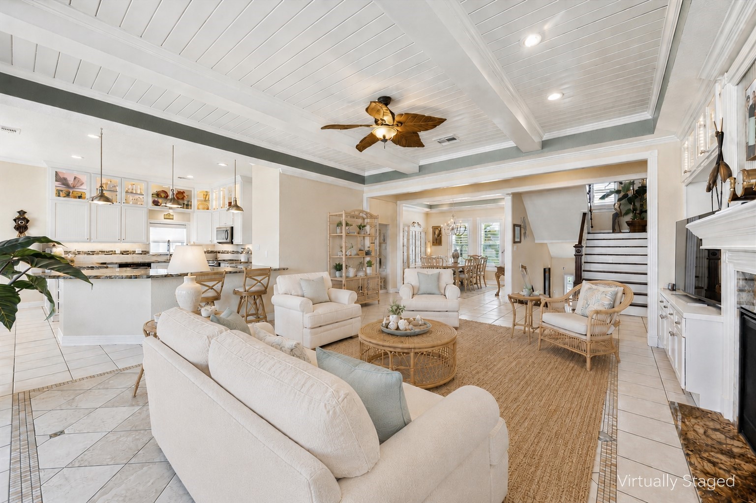 This virtually staged photo shows the view from the back of the home and the wonderful flow between the kitchen and breakfast room, formal dining room and living room.