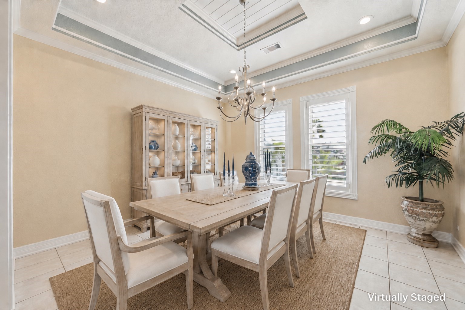 This virtually staged formal dining room features a continuation of the beadboard ceiling, extensive crown molding and trim detail as well as designer paint colors chosen from historic Galveston homes.
